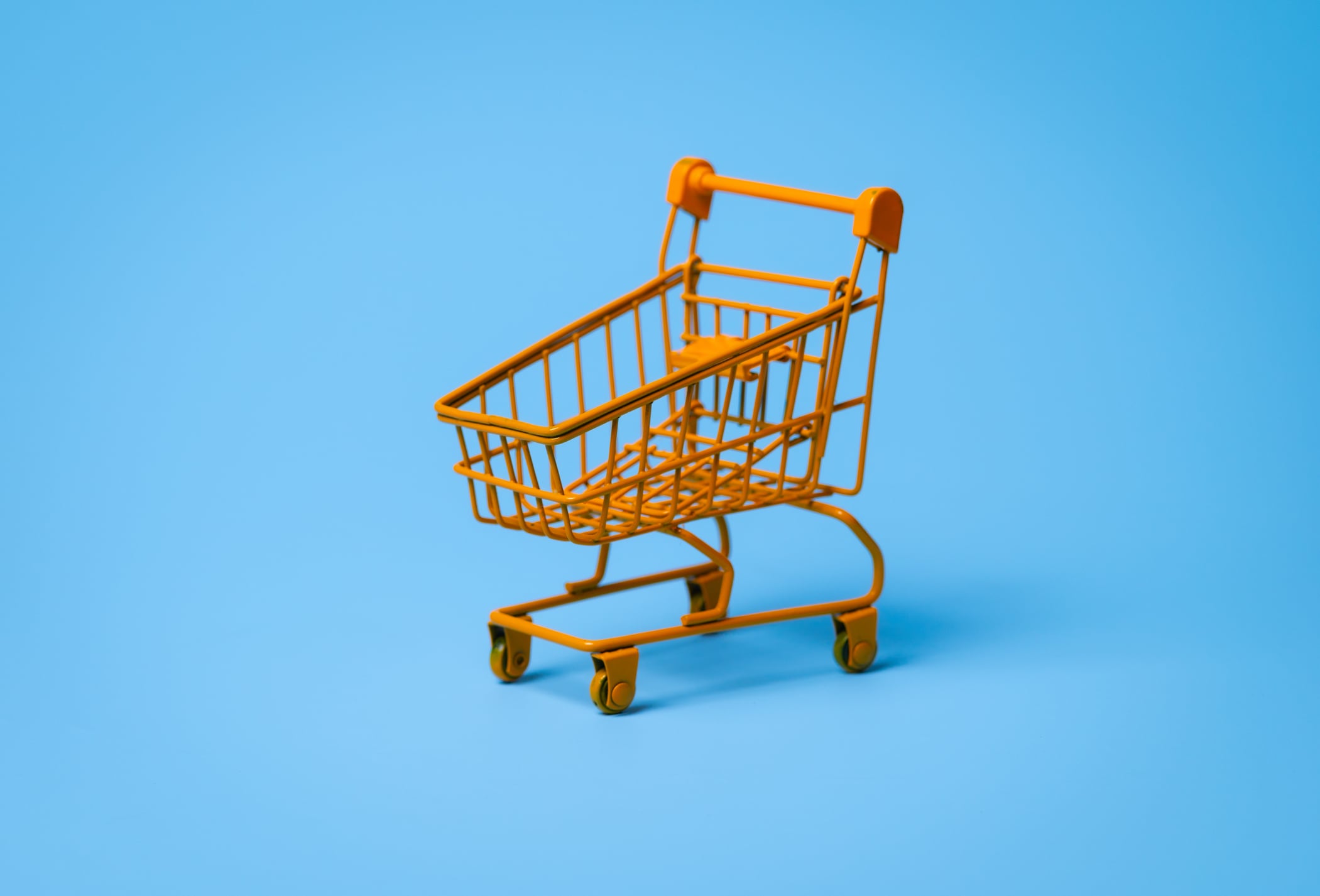 Empty shopping cart on blue background