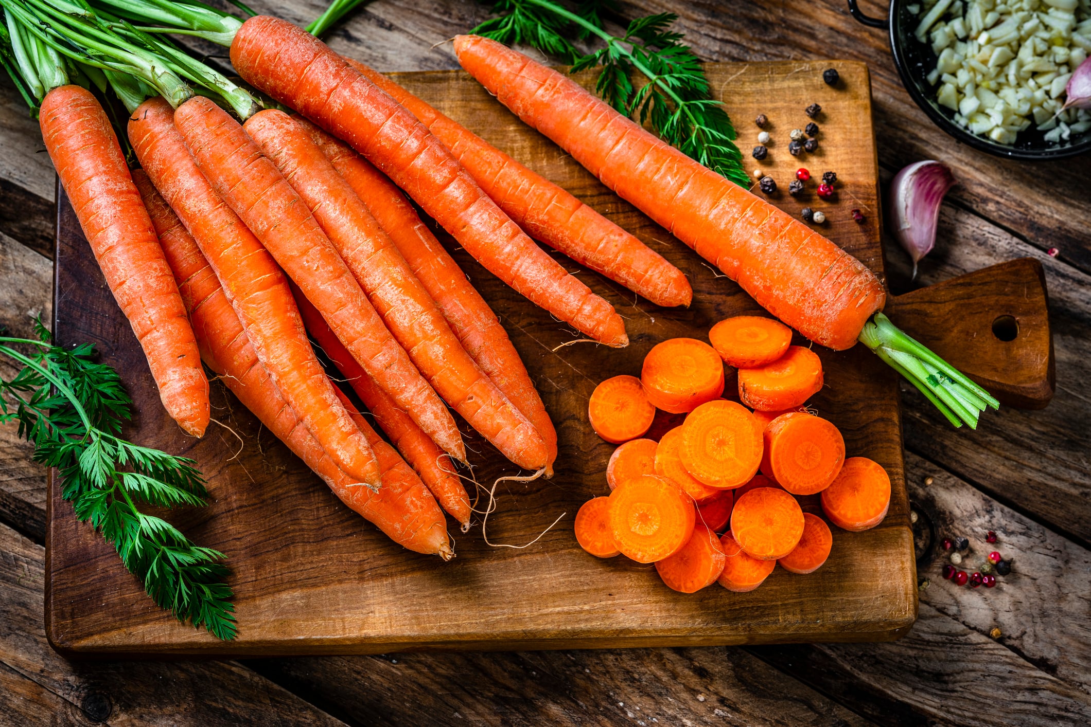 Overhead view of freshly sliced organic carrots on cutting board. High resolution 42Mp studio digital capture taken with Sony A7rII and Sony FE 90mm f2.8 macro G OSS lens