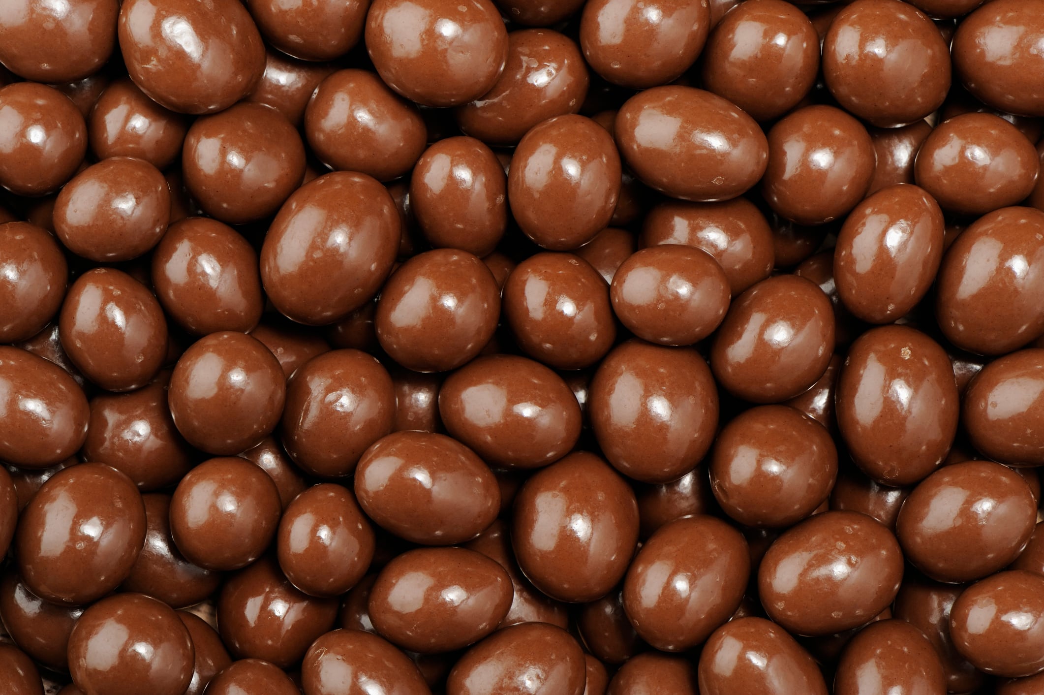 Stack of peanuts dipped in milk chocolate.