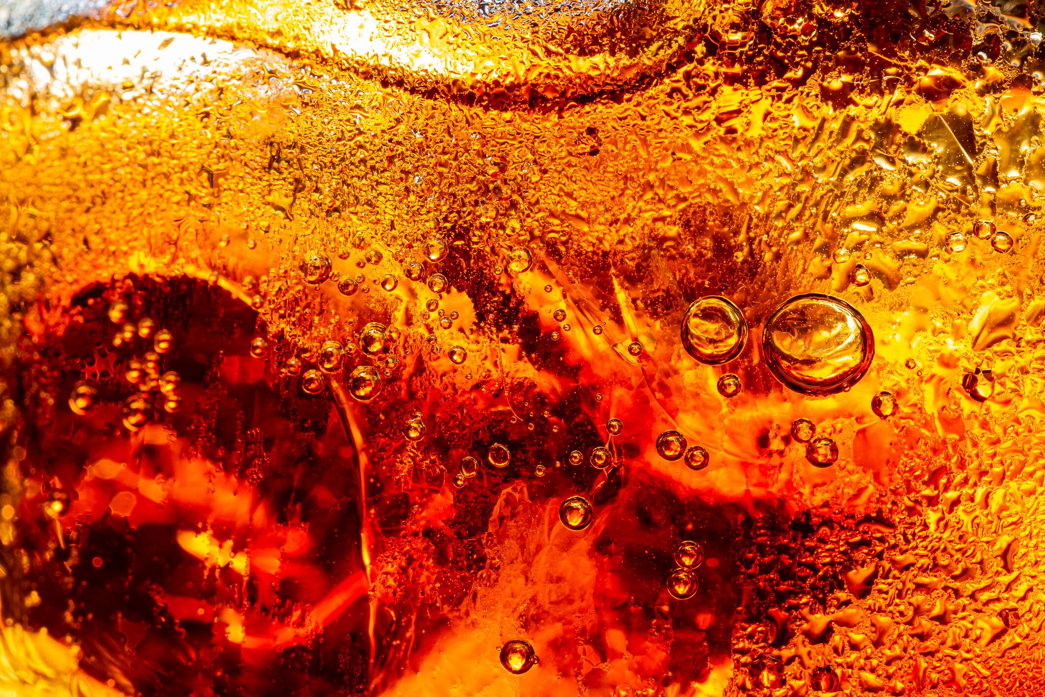 macro soft drink,Glass of tasty refreshing cola with ice cubes on black background, closeup,Cola close-up