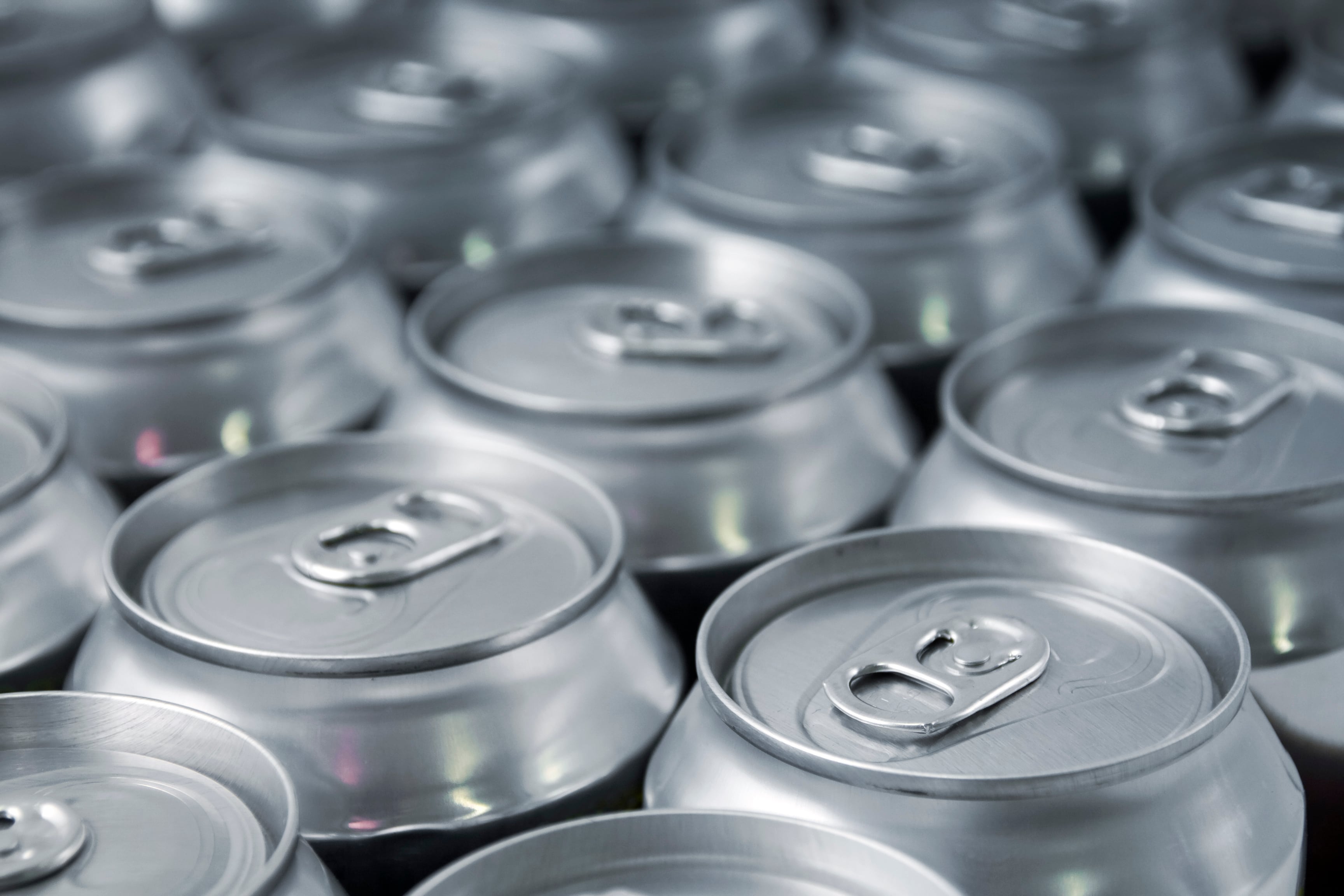 Lots of soda/beer cans in rows. Focus on closest can.Other drink can images: