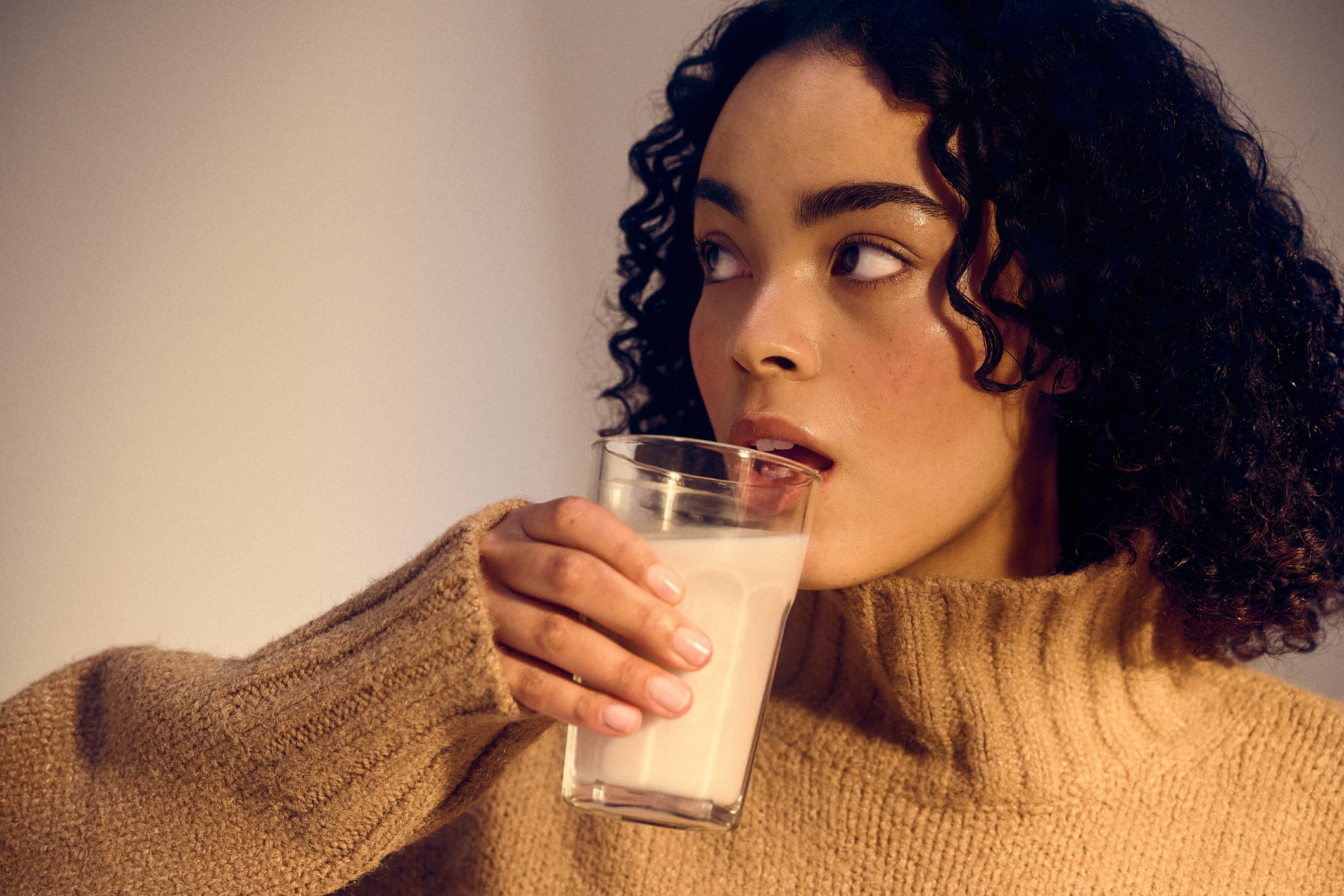 Woman drinking a glass of milk
