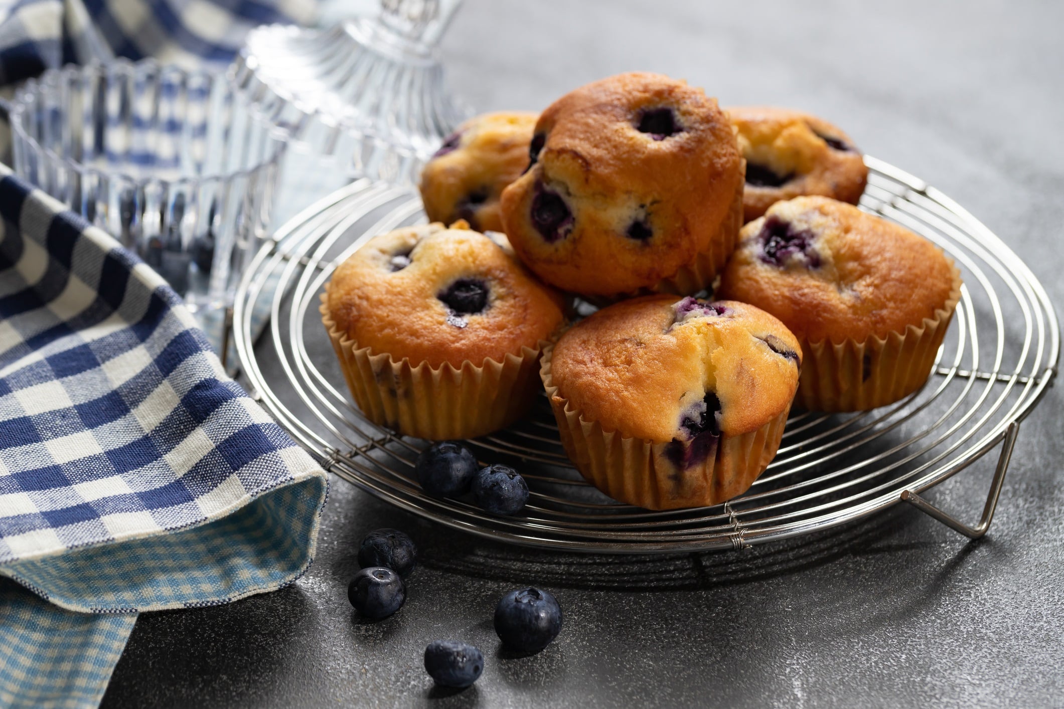 Close-up shots of blueberry muffins surrounded by blueberries.