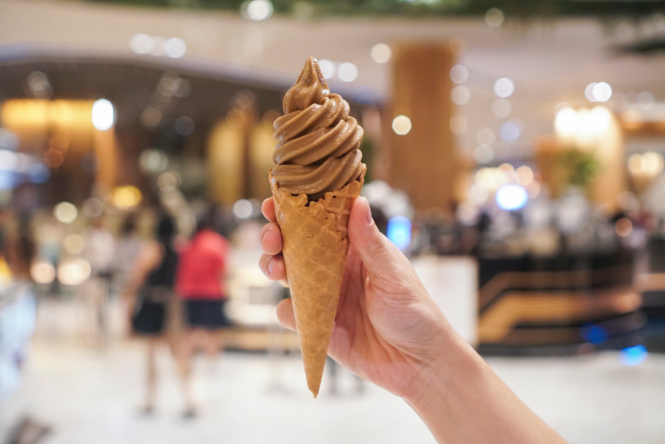Hojicha soft serve ice cream in waffle cone.