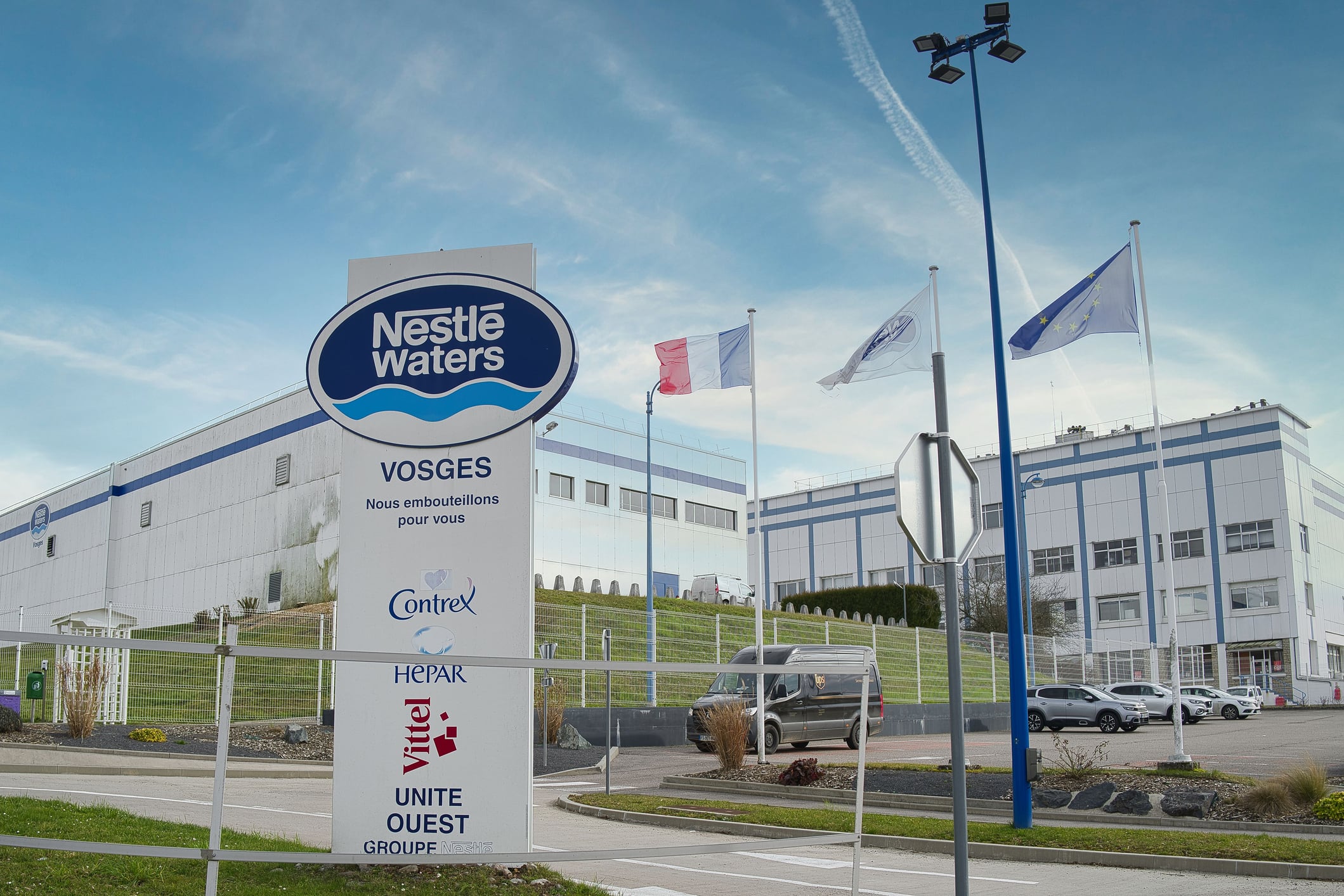 VITTEL, France – March 22, 2022: A scenery of Vittel mineral water factory with "Nestle Waters" signboard in front