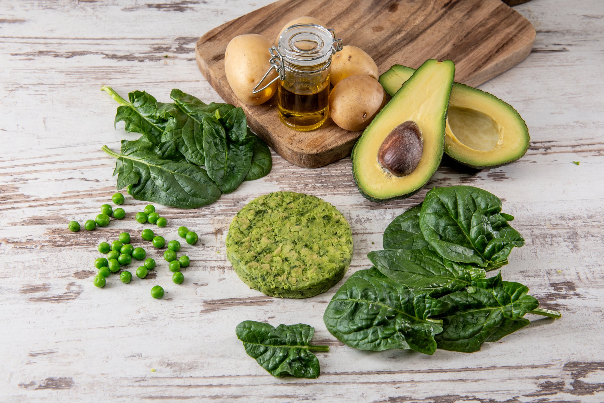 Vegan burger ingredients isolated on a  table (spinach , peas , greens , avocado)