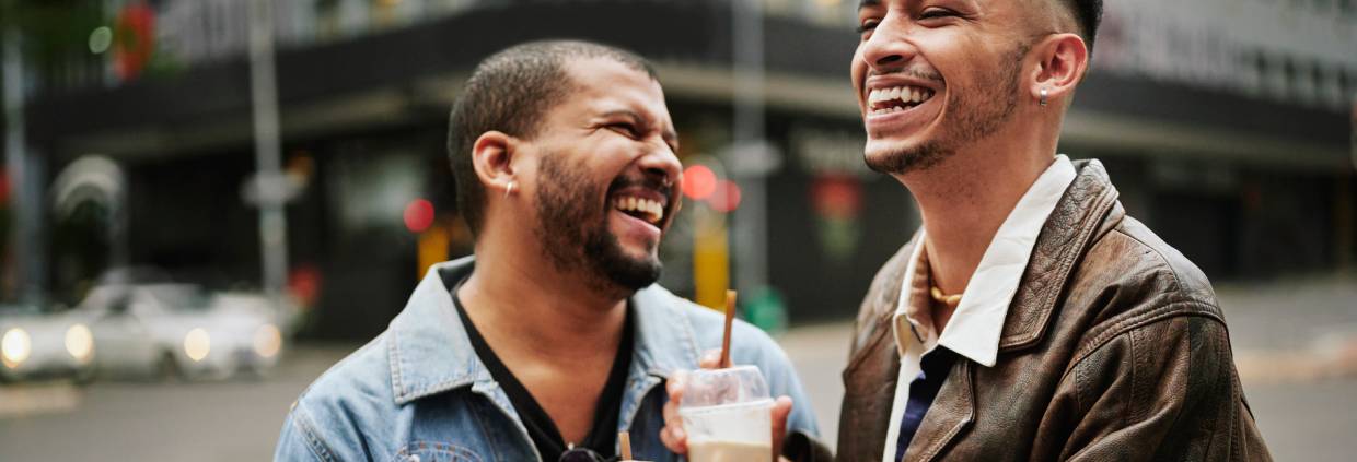 Two men drinking coffee on the street