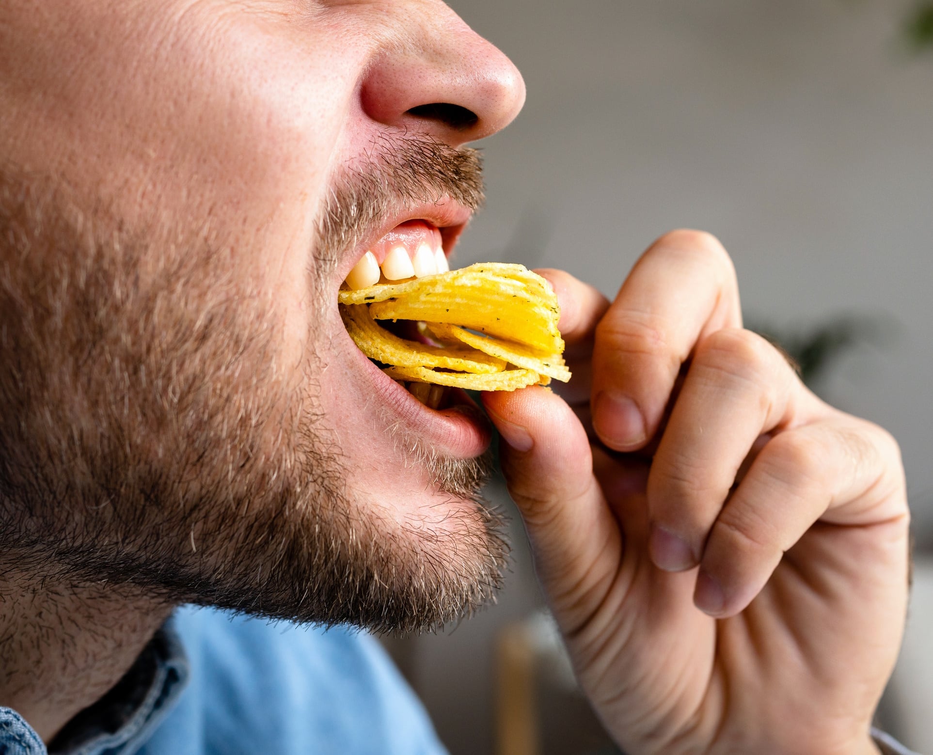 Close up of man eating chips