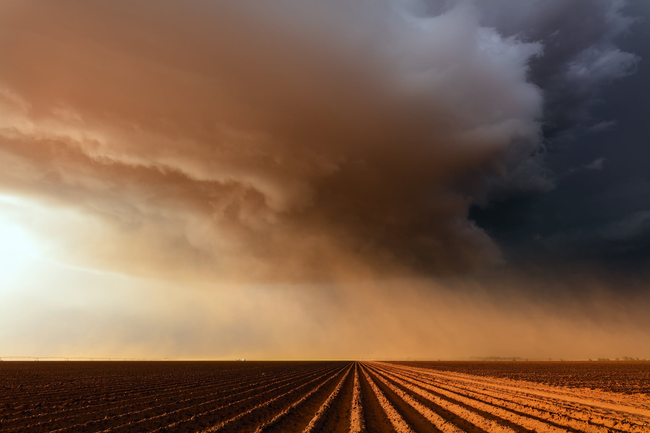 Dramatic dust storm with ominous clouds over a farm field near Lubbock, Texas, USA.