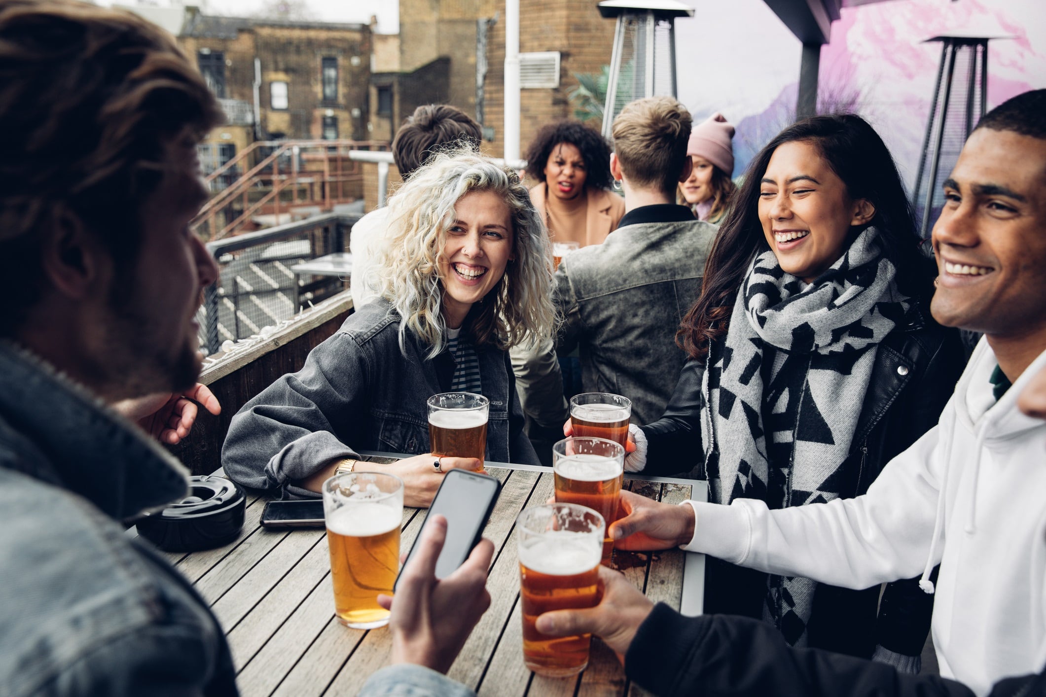 Group of friends drinking beers in a pub.