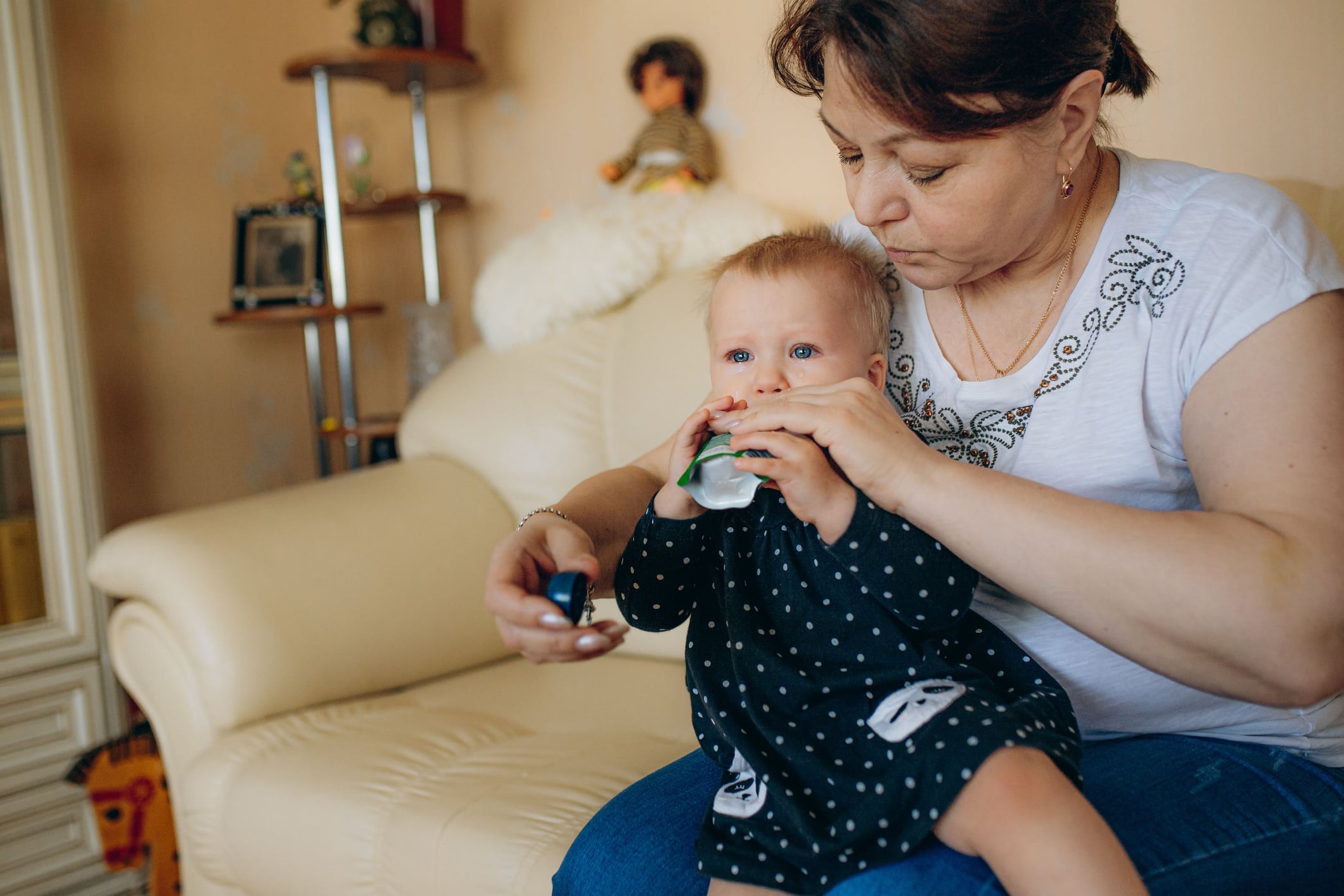 Baby eating from food pouch
