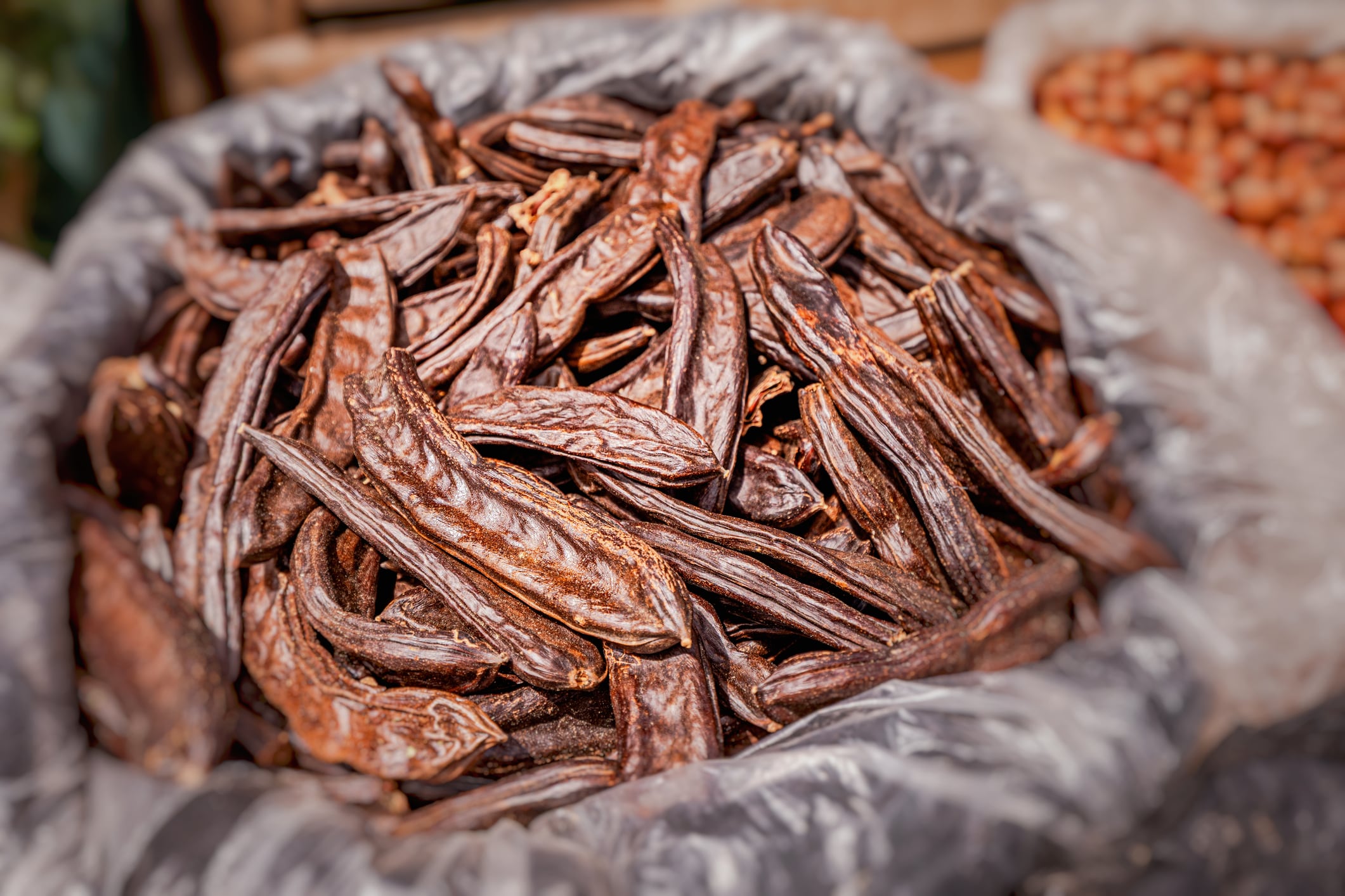 Carob pods in a sack