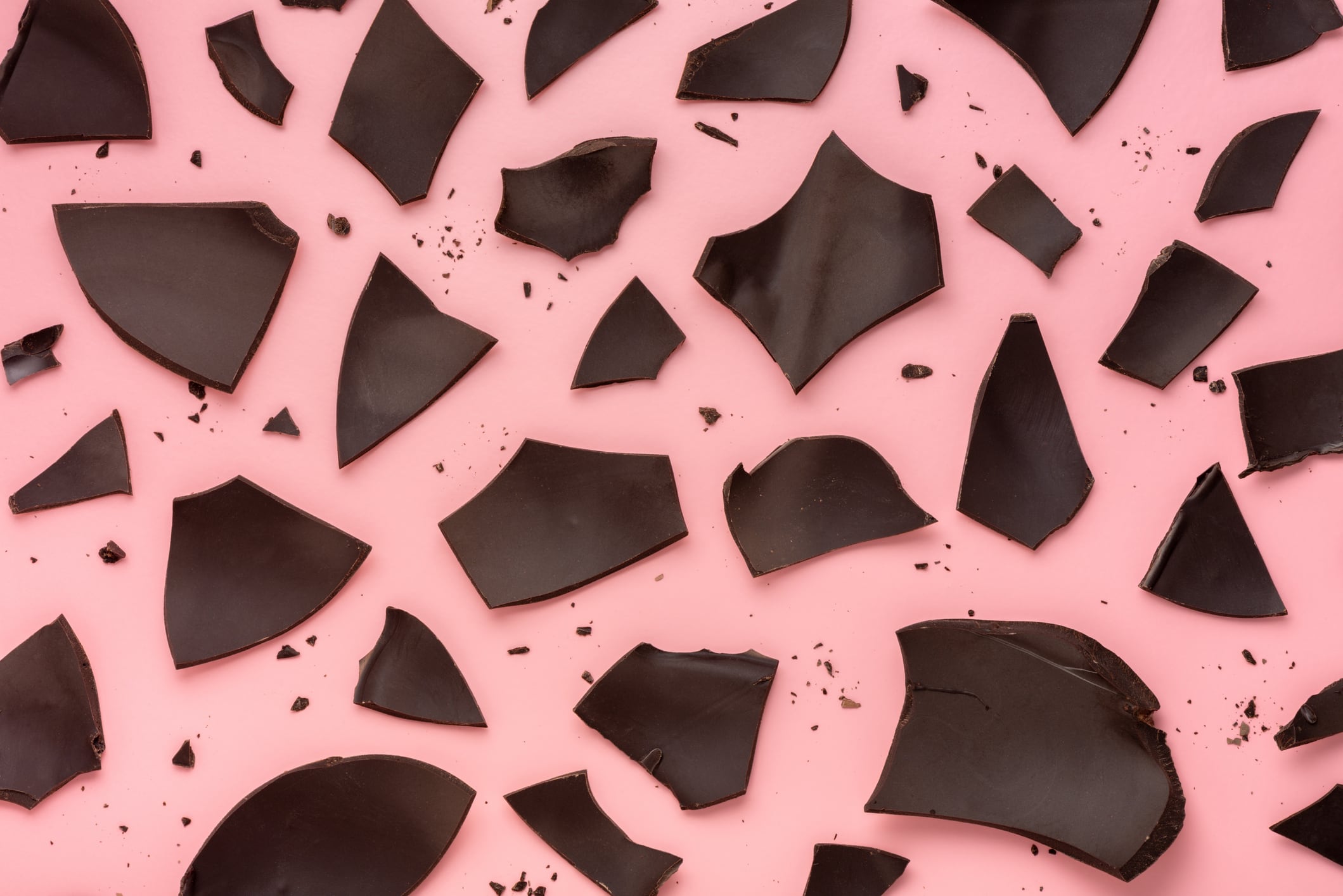 exploded chocolate Easter egg over pink background, holiday concept