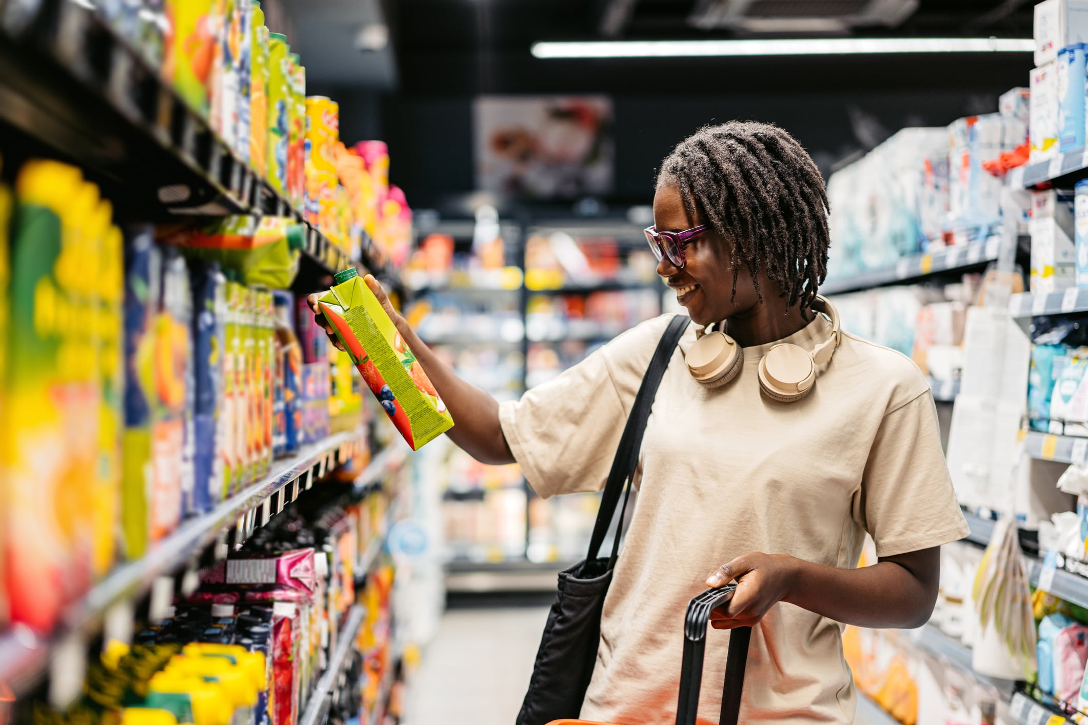 Woman shopping for juice at the supermarket.