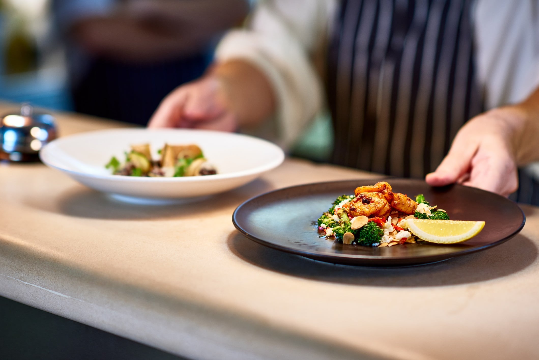 Professional chef working in commercial kitchen, preparing food, serving meal, service.
