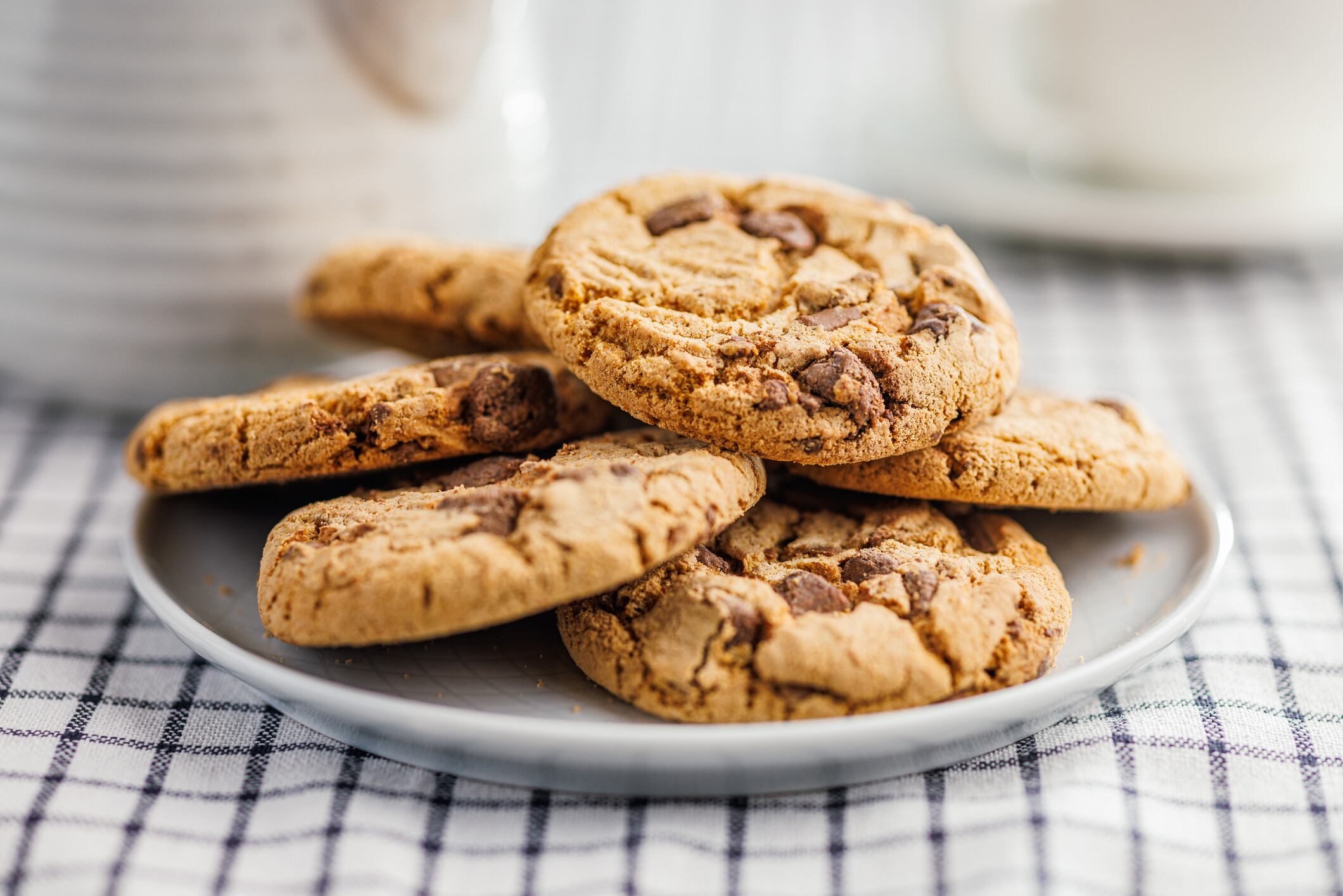 Sweet chocolate cookies on plate on the checkered napkin.