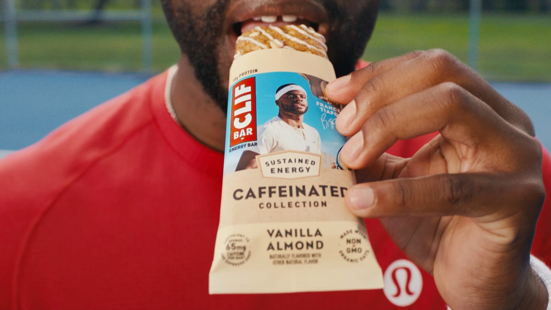 Man eating Clif Bar's Caffeinated snack bar in vanilla almond.