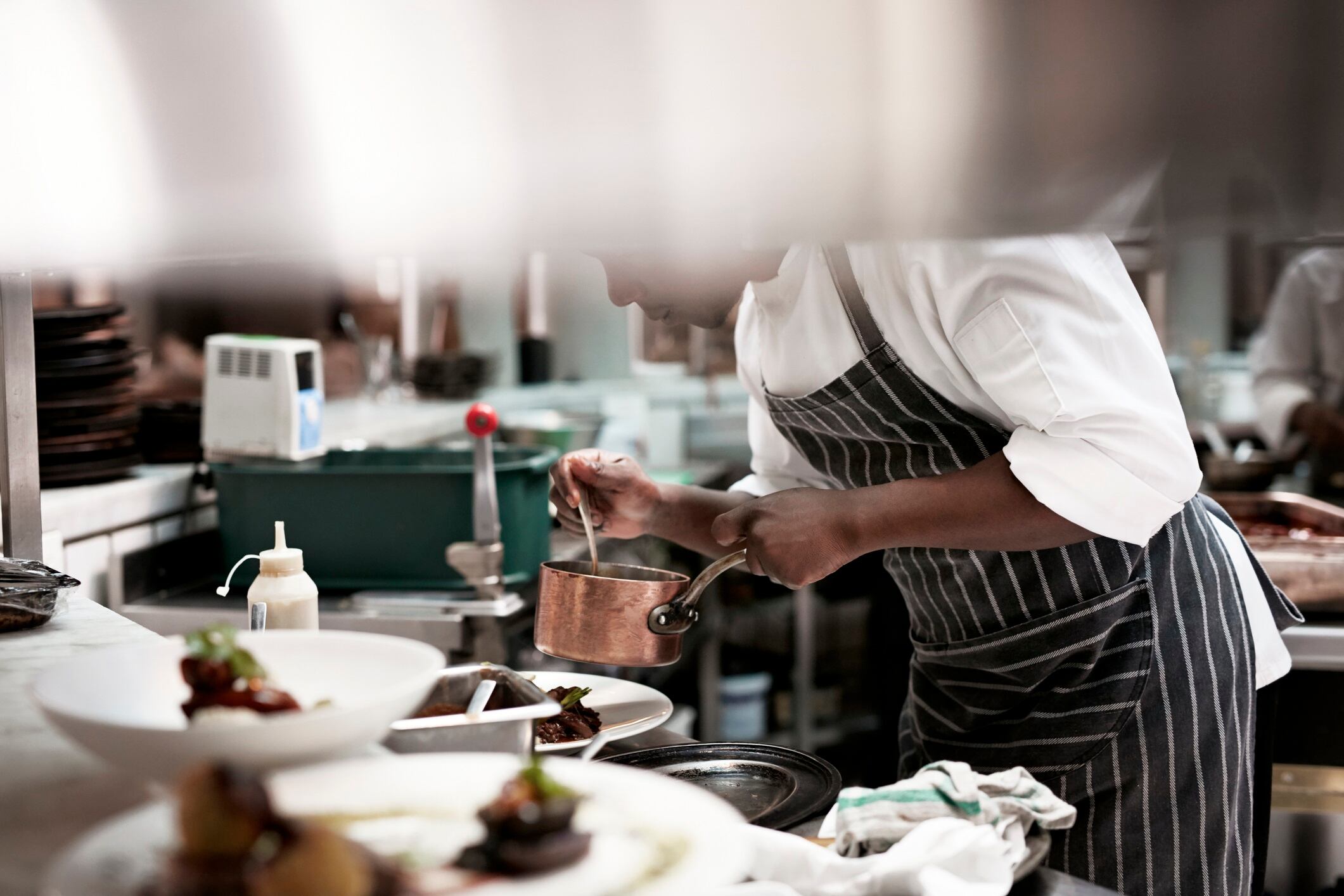 Chef finishing dishes at restaurant