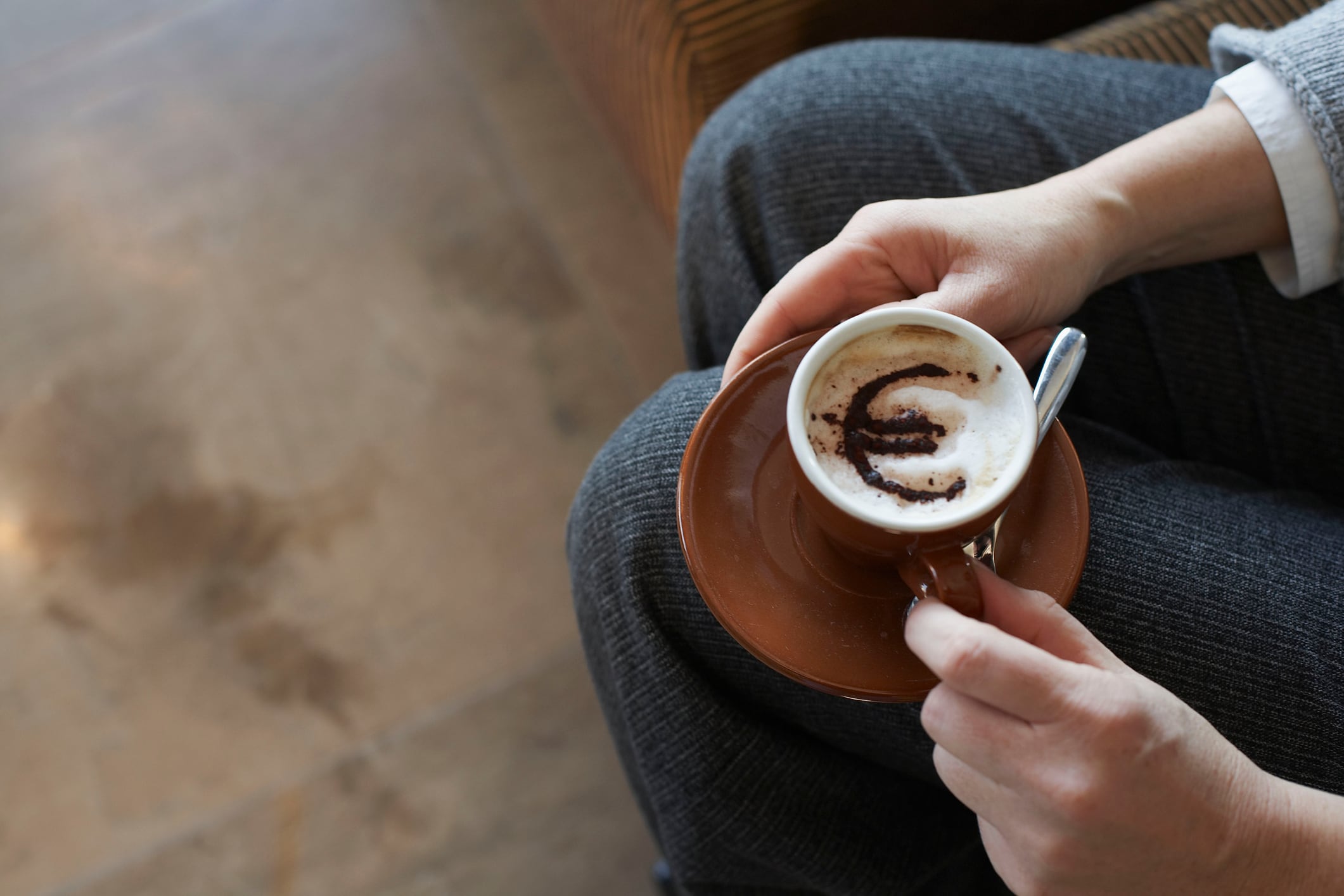 Holding cappucino with Euro