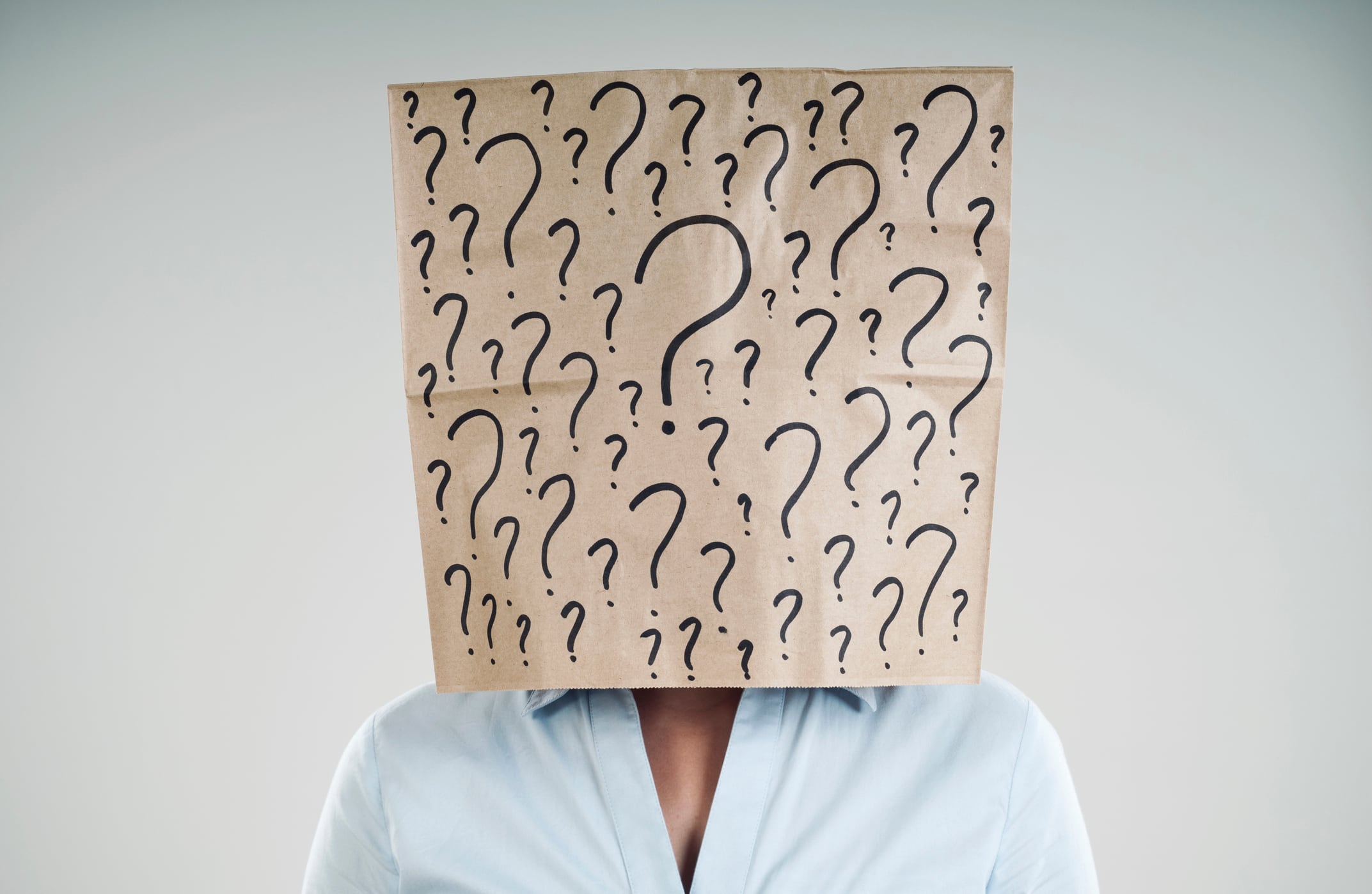 woman wearing a paper bag with questions mark