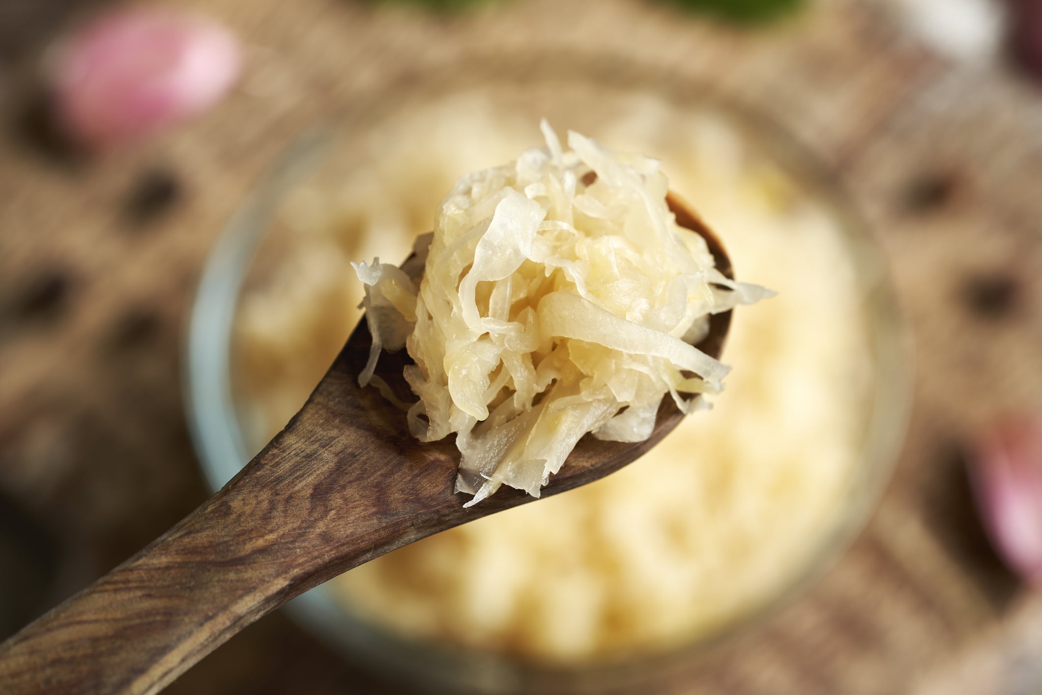 Homemade fermented cabbage or sauerkraut on a wooden spoon