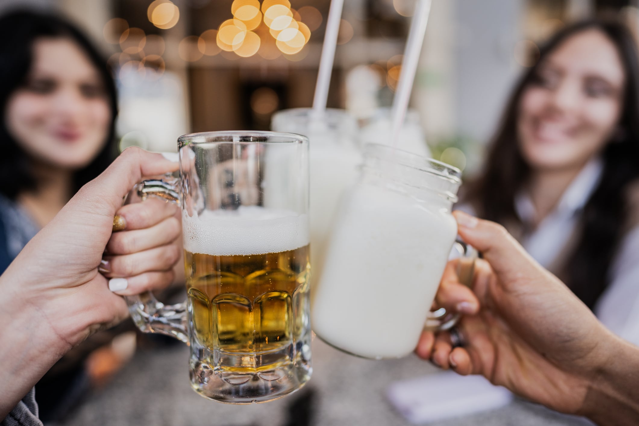 Close-up of a friends toasting on a restaurant.