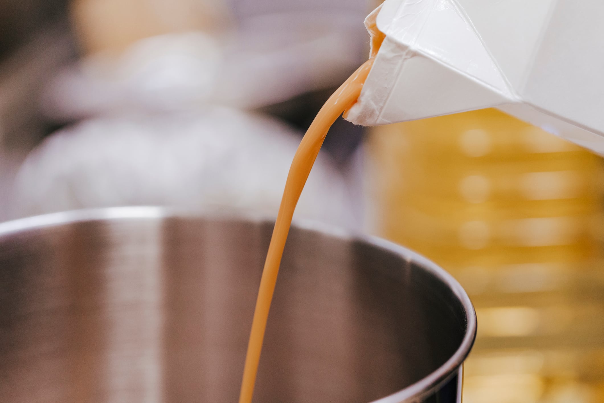 Two Chicks liquid egg business sells to big European brand. Image: close up view of liquid egg pouring into a bowl. recipe and bakery concept