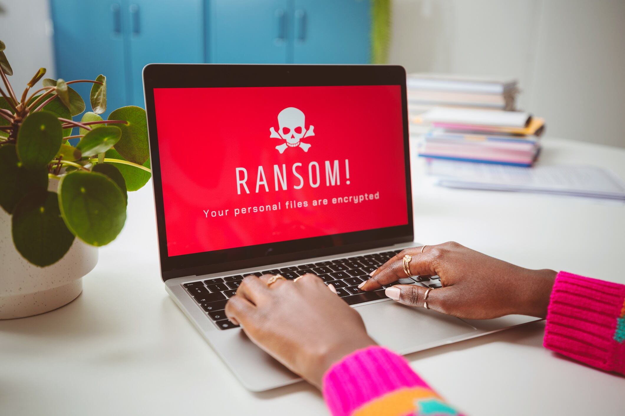 Woman using laptop. Ransomware Malware Attack. Computer Hacked. Unrecognisable person, close up of hands and computer screen.