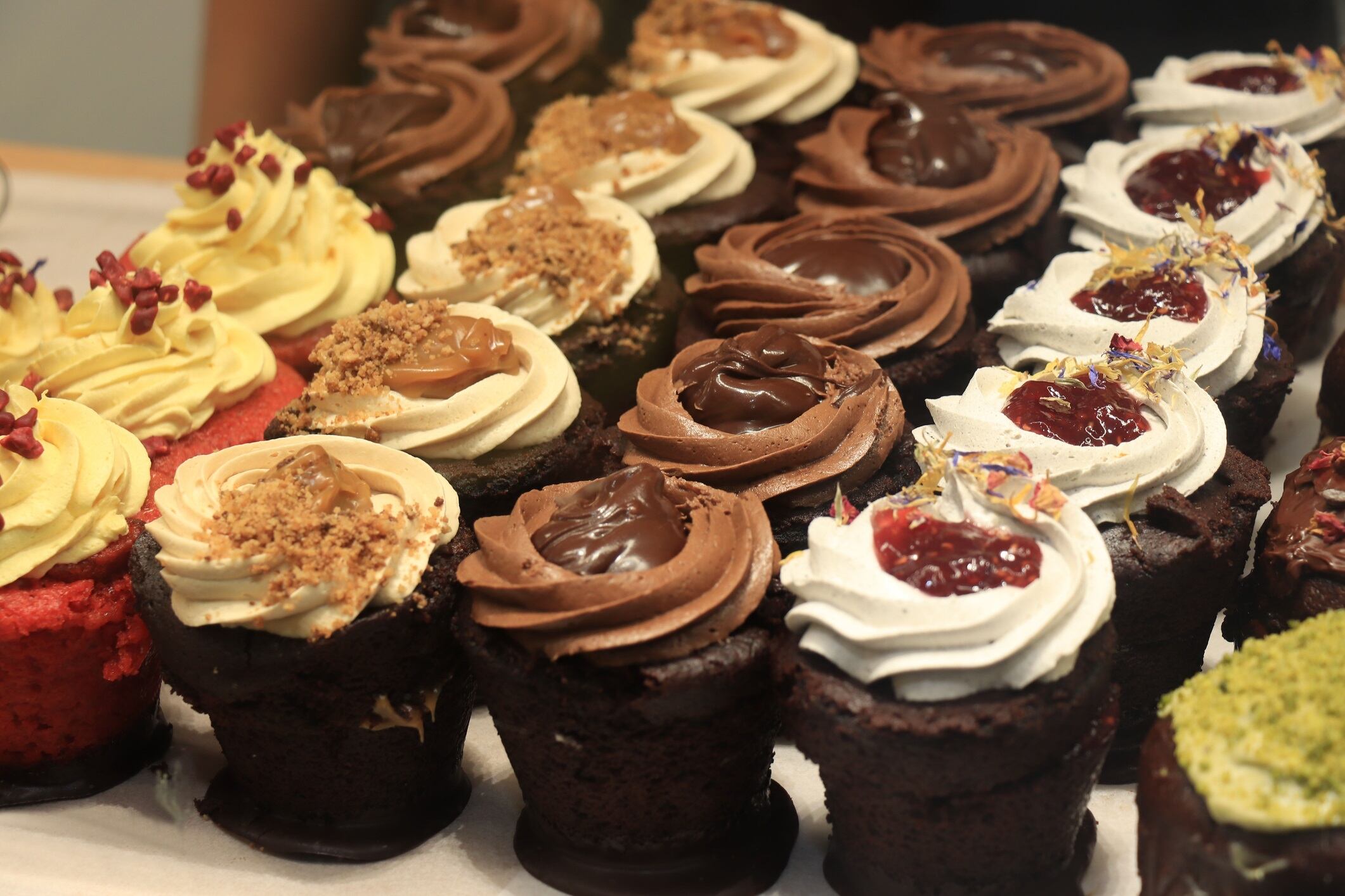 Fresh made chocolate cupcakes on display in a shop window
