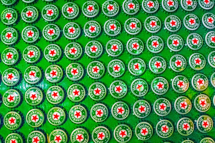 Amsterdam, The Netherlands - March 4, 2006: Closeup of a large display of Heineken beer bottle caps.
