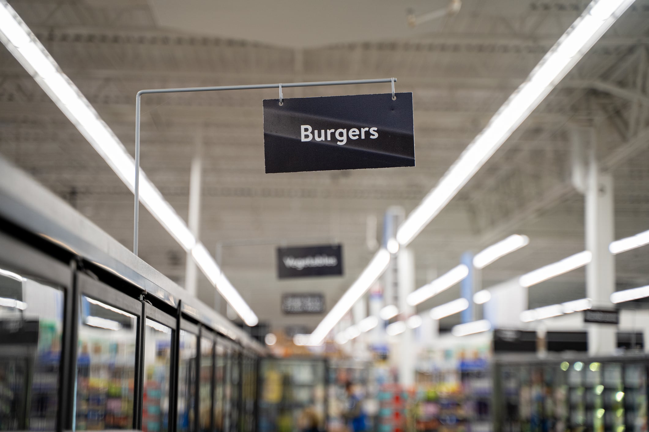 Close up of burgers aisle sign in supermarket.