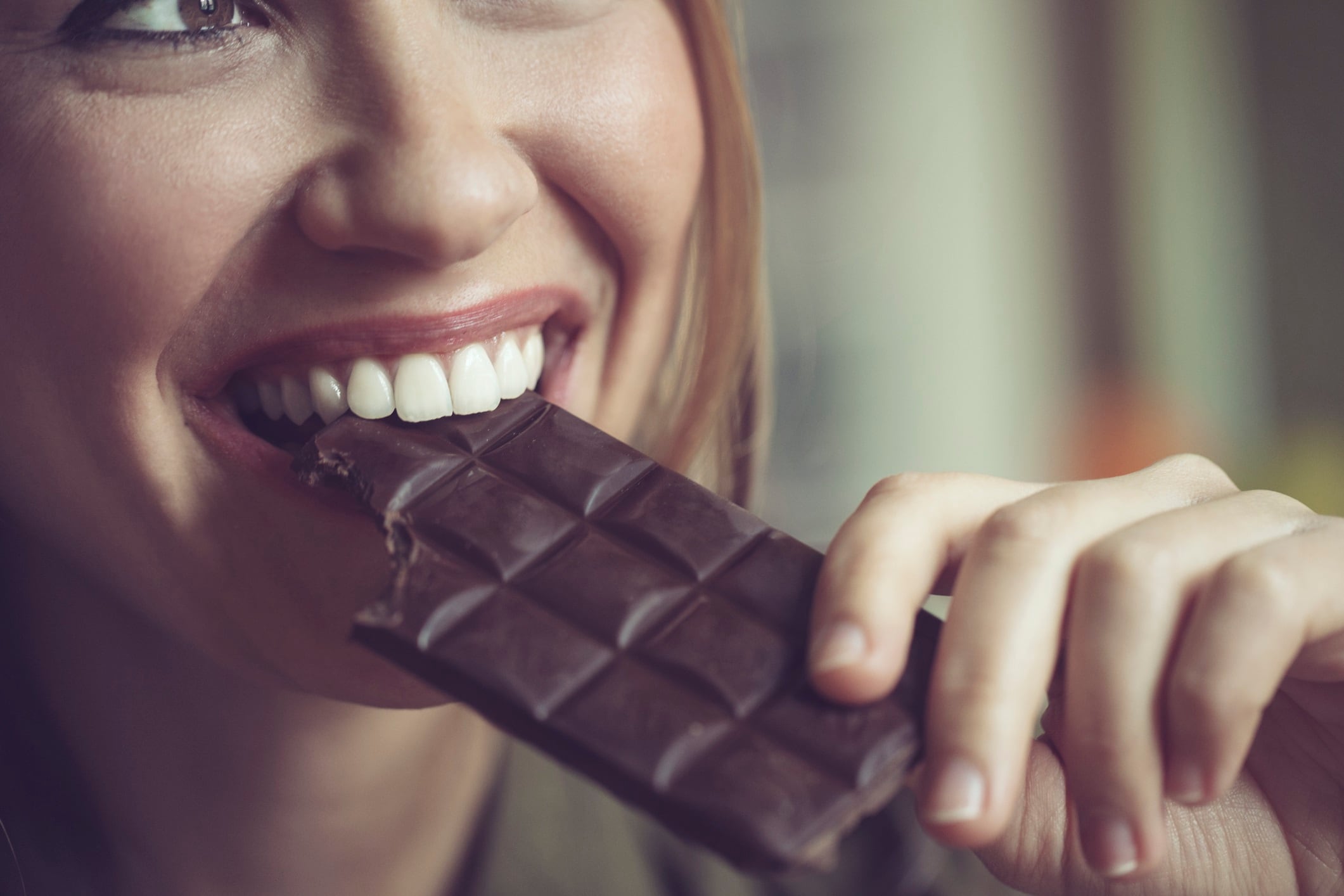 Woman eating dark chocolate