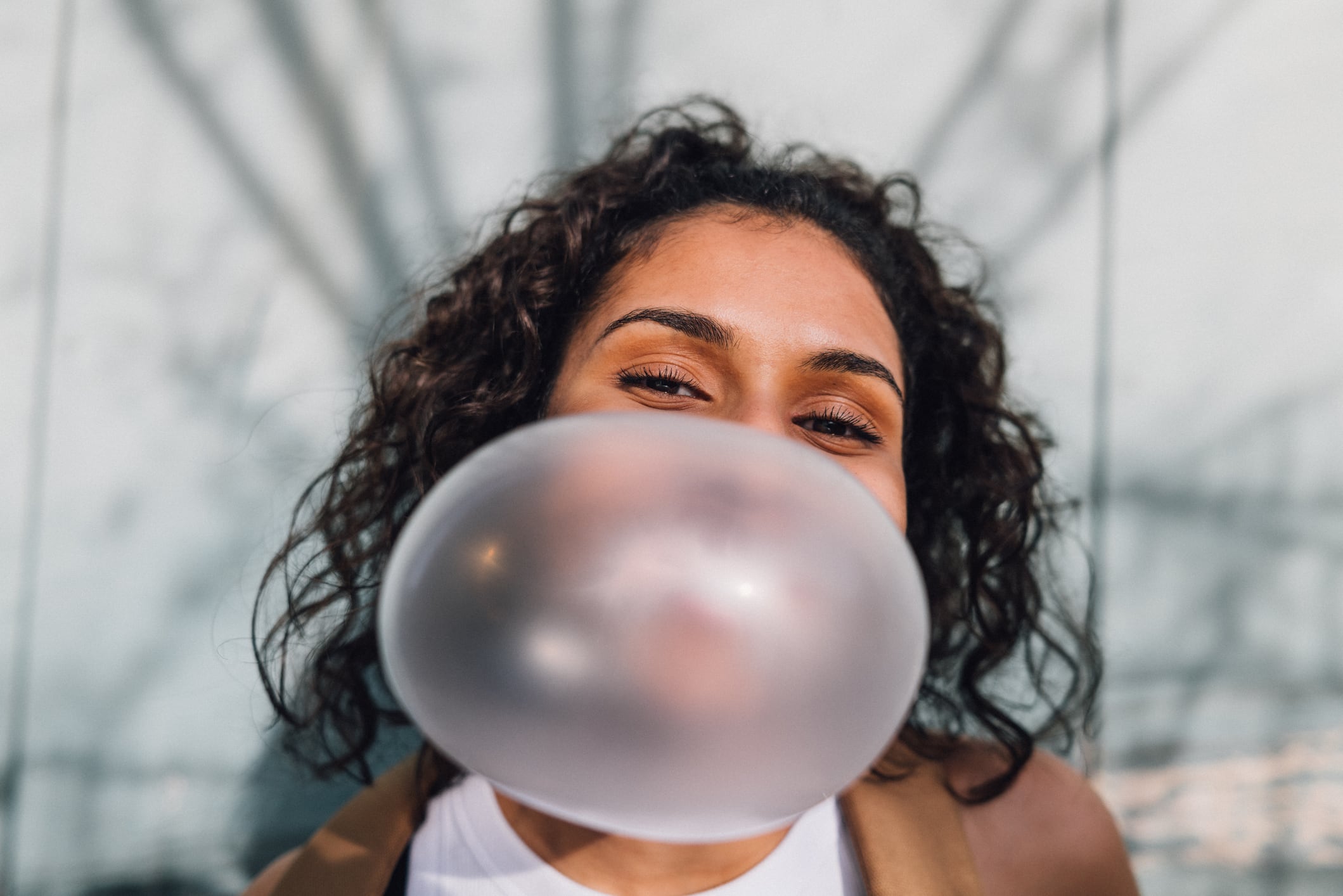 Young woman spending day outside in residential area in city. Part of a series with video