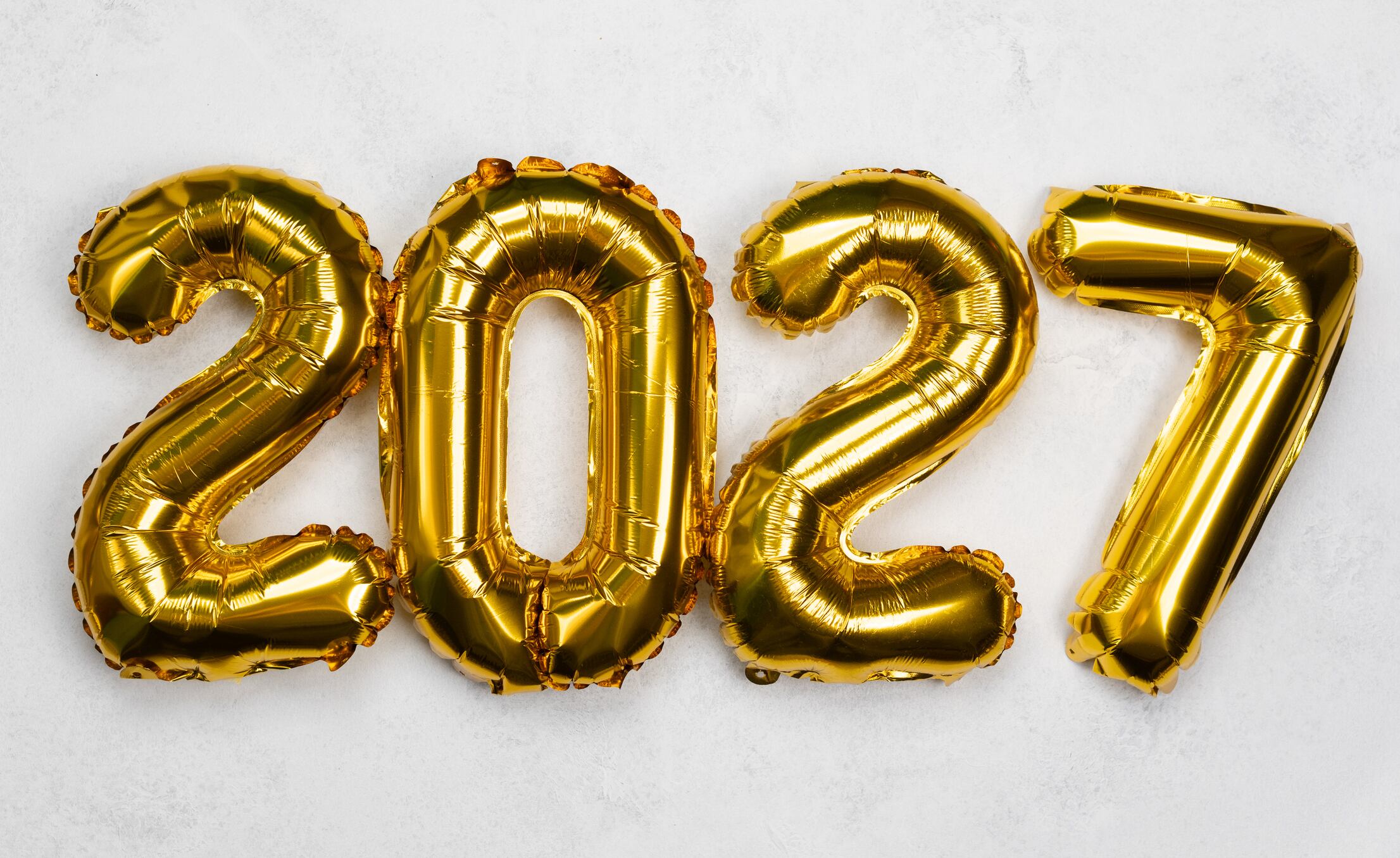 Shiny gold balloons arranged to show the year 2027 for a special event celebration.Happy New Year celebration