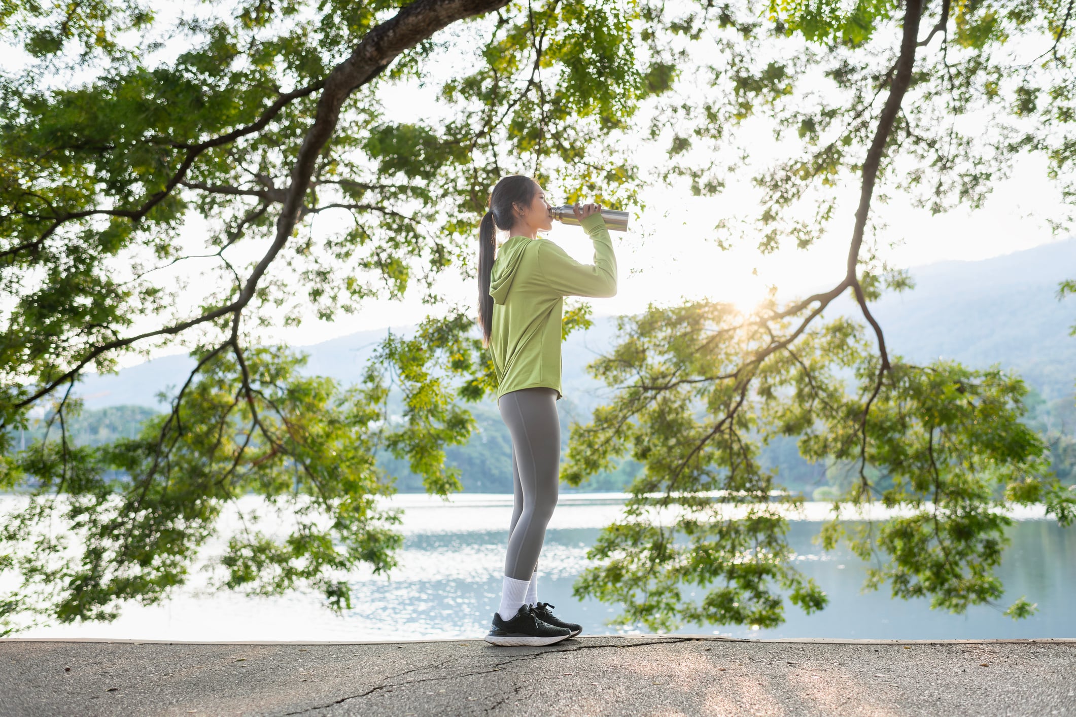 Woman drinking water by water