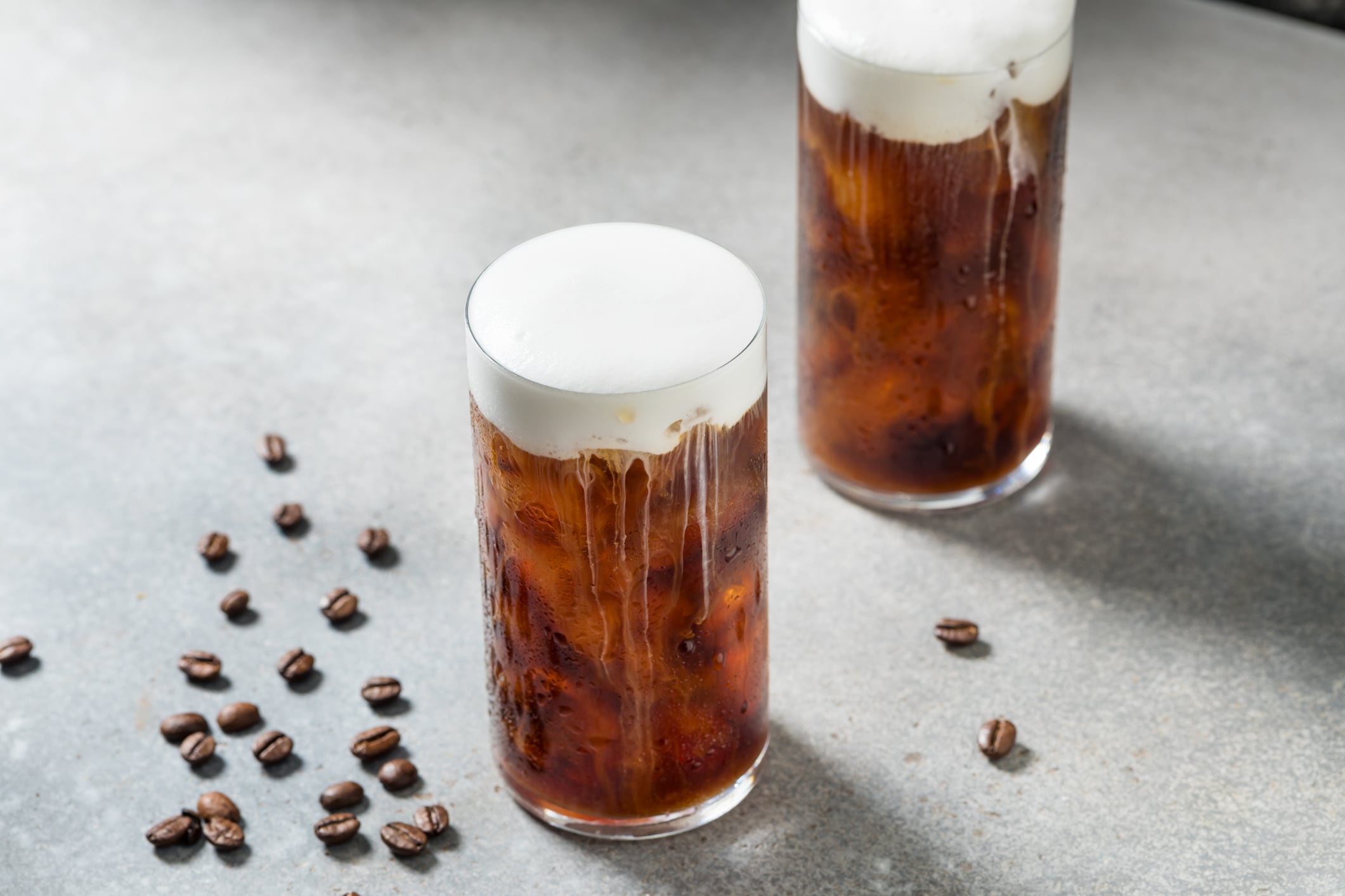 Refreshing Espresso Coffee with Cold Foam and Ice Cubes
