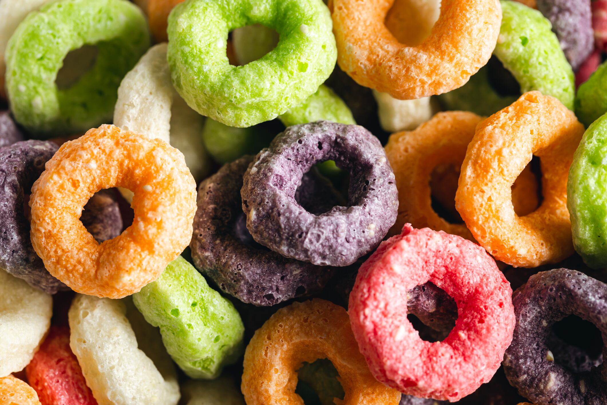 Colored breakfast cereals, food background, children's healthy breakfast, close up.
