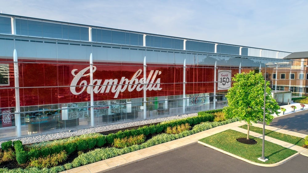 The Campbell’s Company is closing three facilities and cutting its salaried workforce as part of a $500 million savings program aimed at improving margins and cash flow.