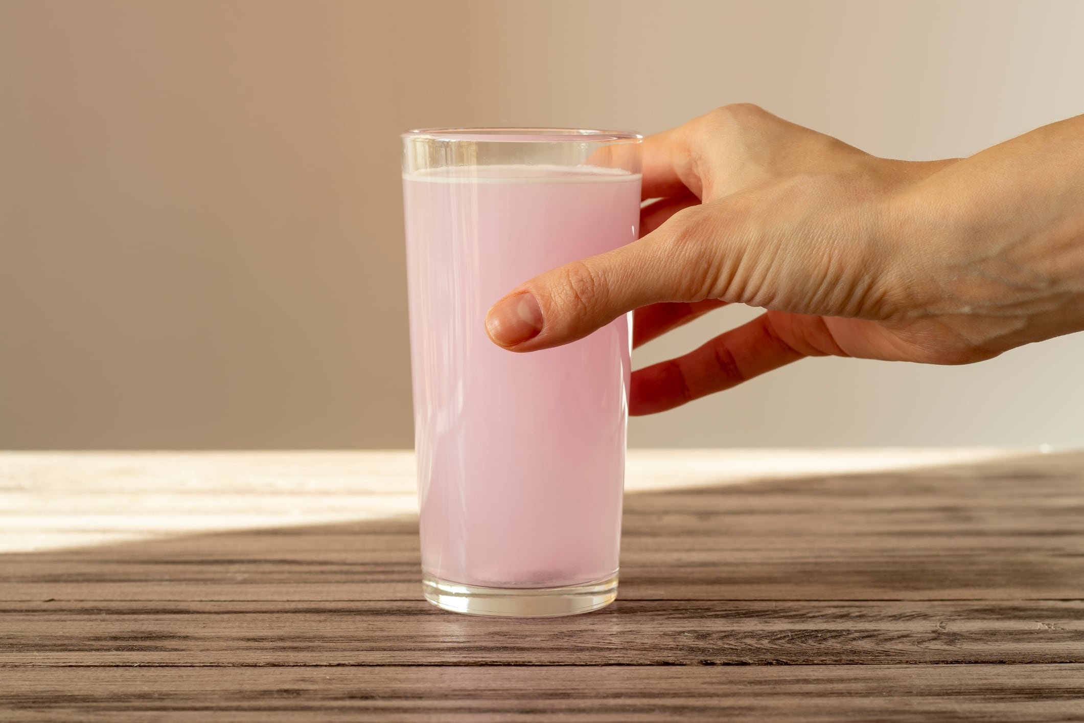 Pink electrolyte tablet dissolves in water