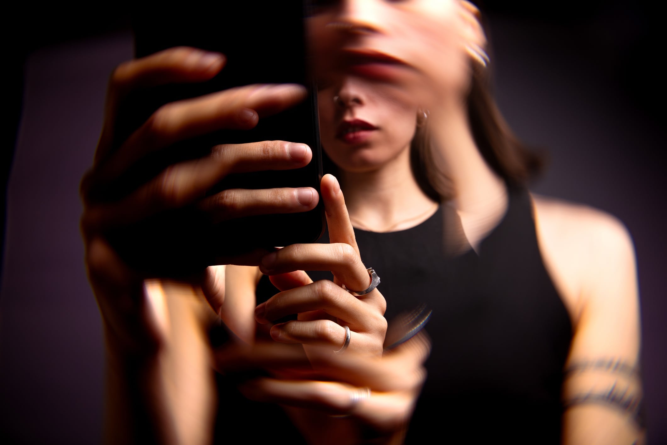 Abstract portrait using a smartphone - scrolling social media Marco_Piunti GettyImages