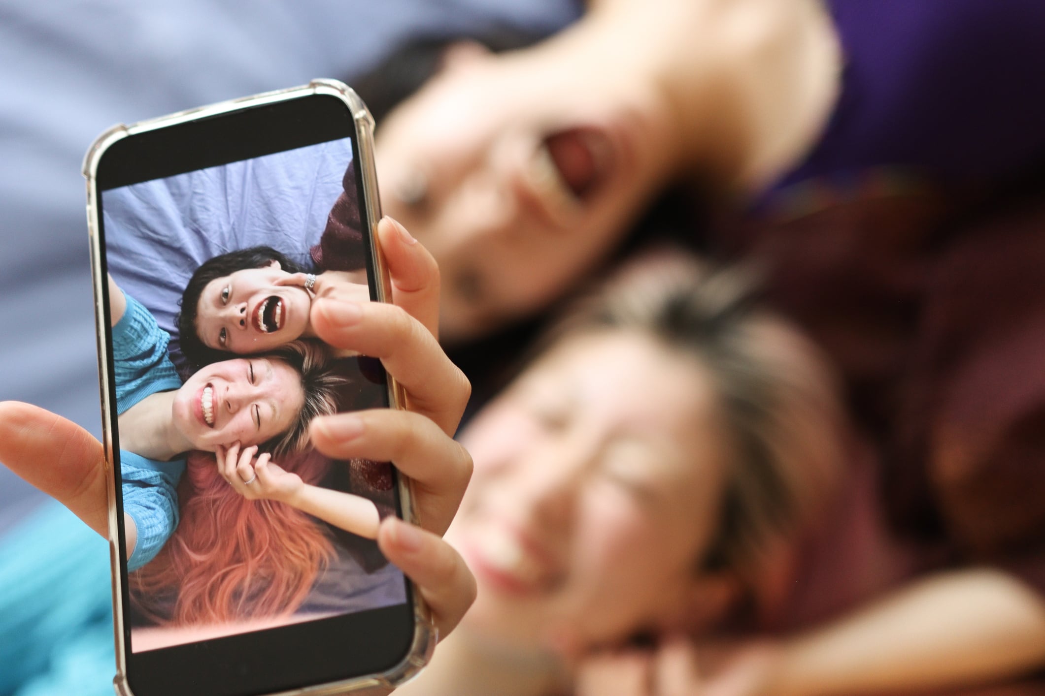 Gen-Z Asian Teenagers talking and laughing happily at home.