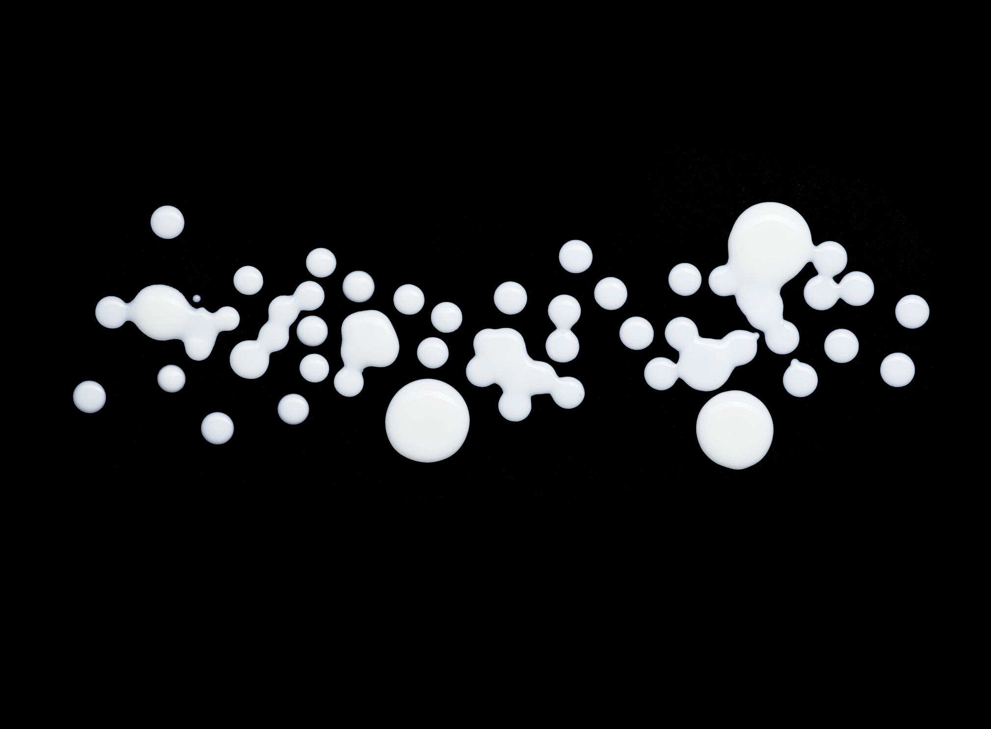 Kefir drops on black background
