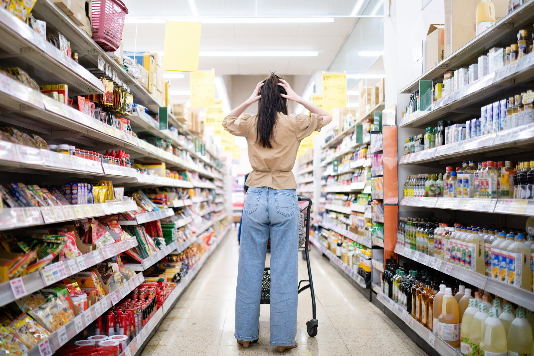 Woman worried at the grocery store due to rising prices