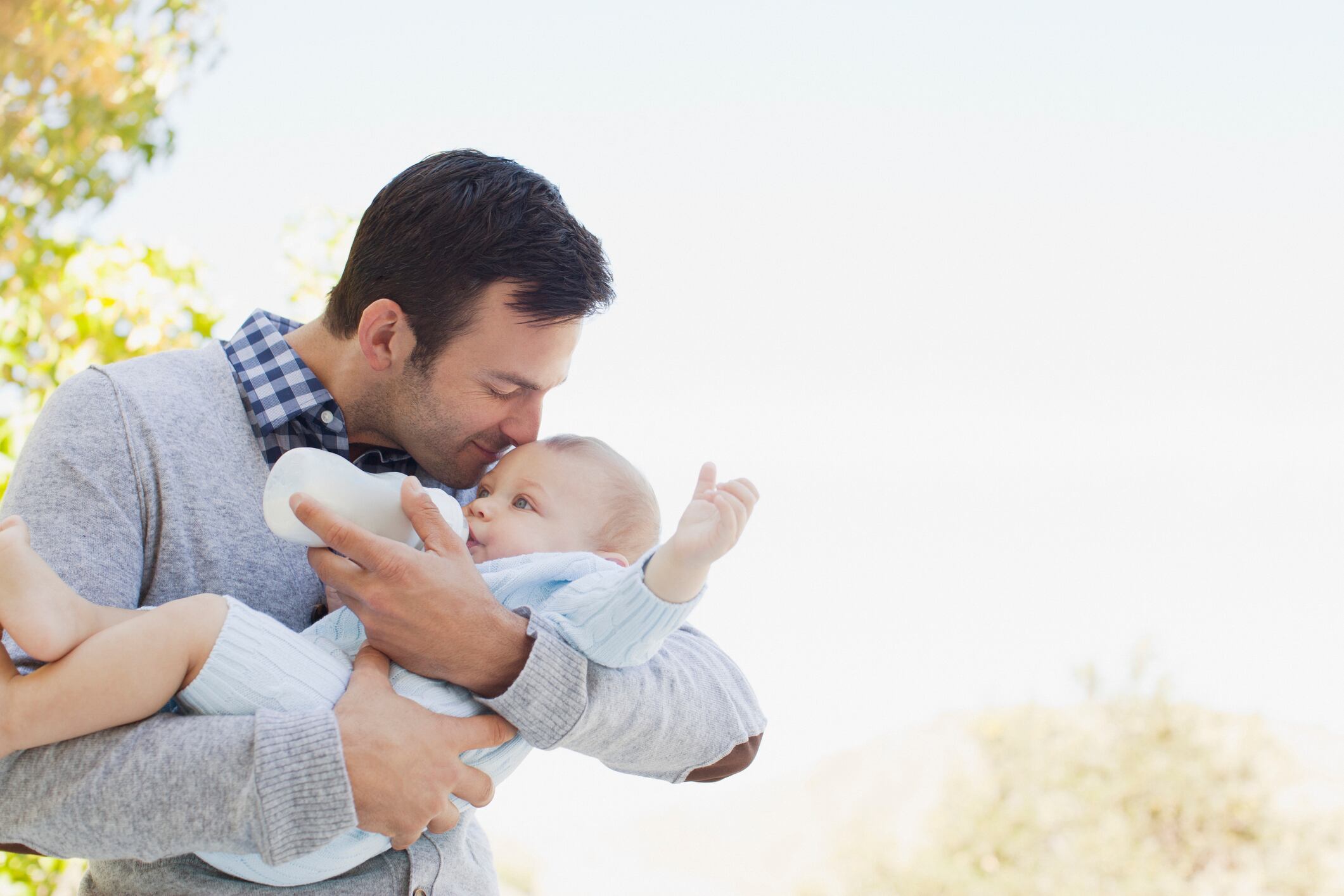 A father bottle-feeding his baby