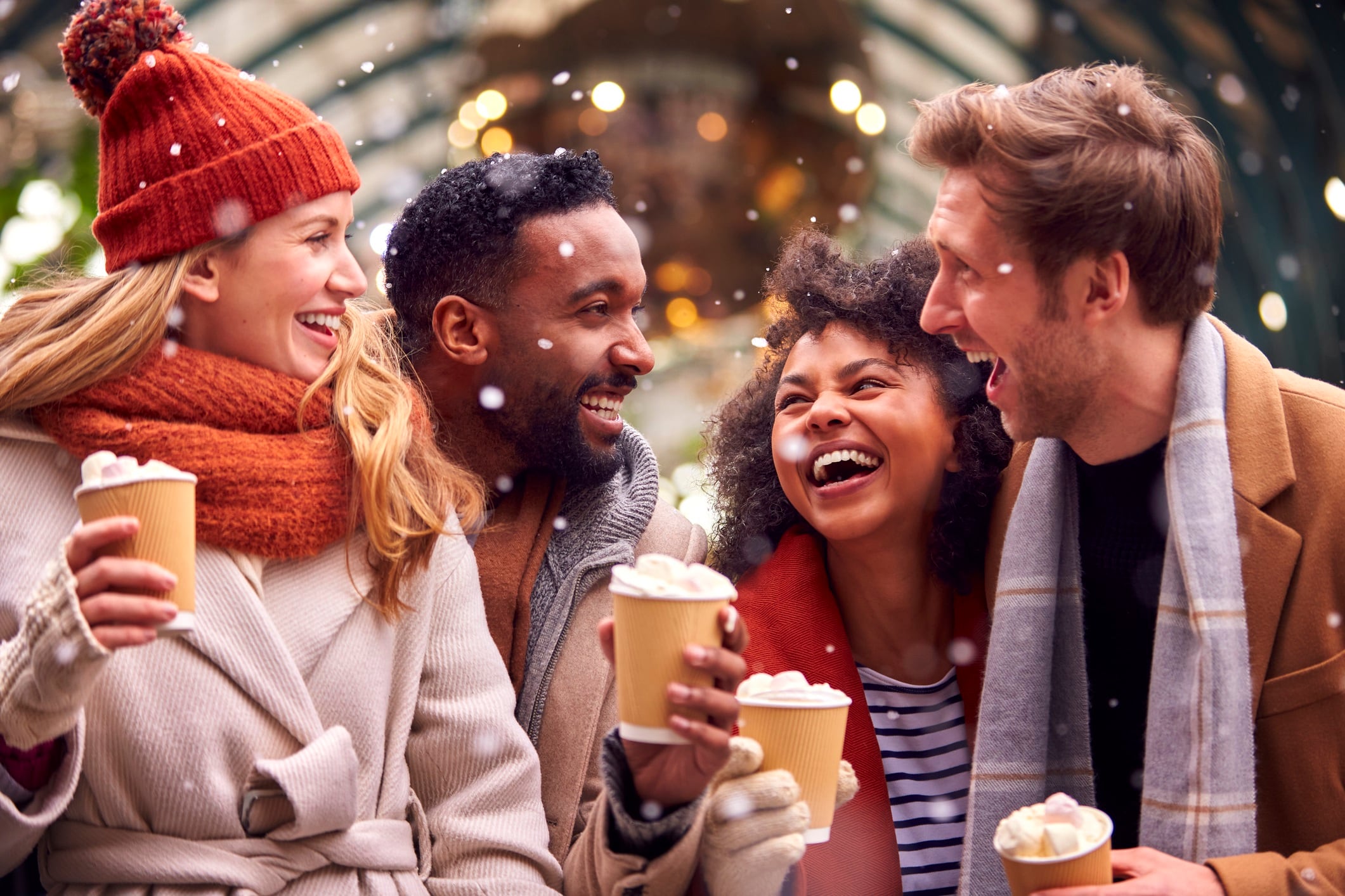 Group of friends drinking hot chocolates outdoors.
