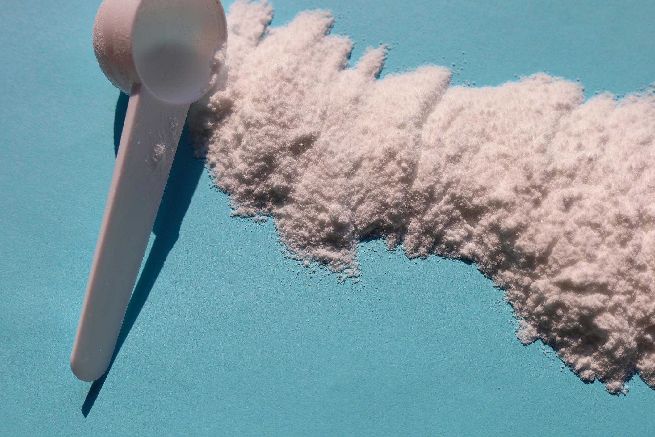 White creatine powder used as a pre-workout performance booster.