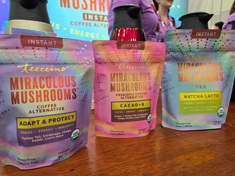 Teecino’s founder Caroline MacDougall showcases the new Miraculous Mushroom instant blends at Natural Products Expo West, featuring brightly colored packaging and a five-mushroom adaptogen formula.