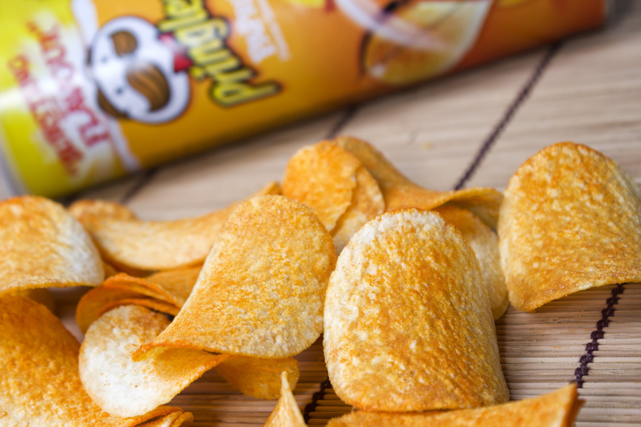Milan, Italy - April 24, 2013: Pringles potato chips in front of snack size Pringles can. Pringles was invented by Procter and Gamble but in April Procter and Gamble agreed to sell the Pringles brand to Diamond Foods of California.