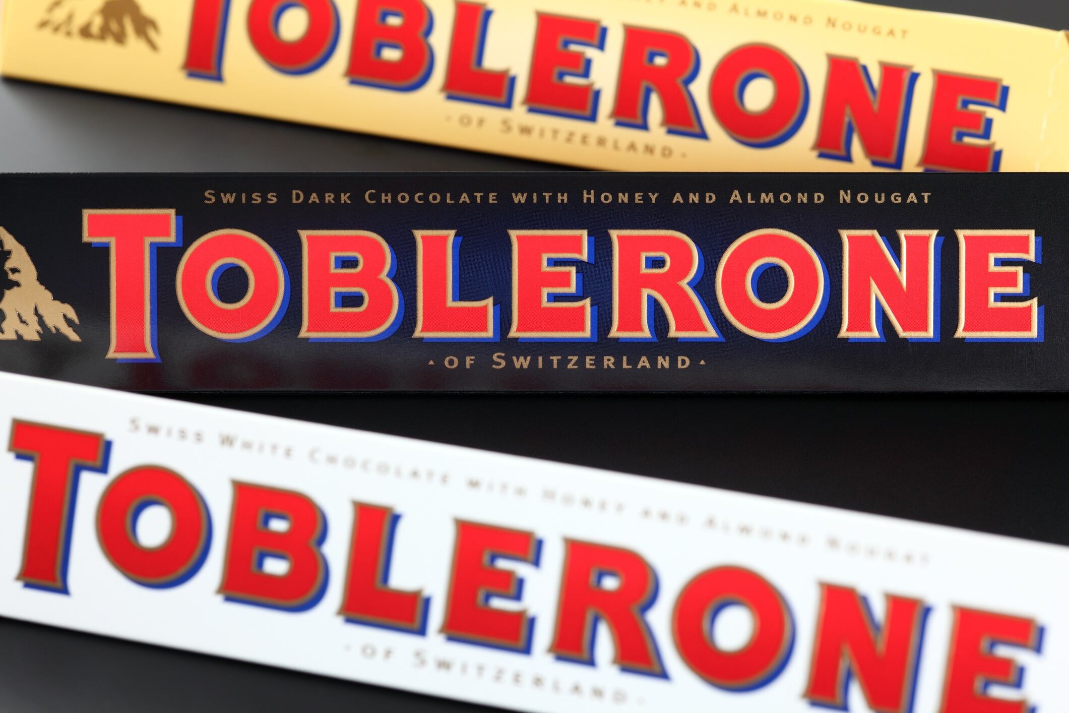 Toblerone chocolate bars. Swiss white, dark and milk chocolates with honey and almond nougat.