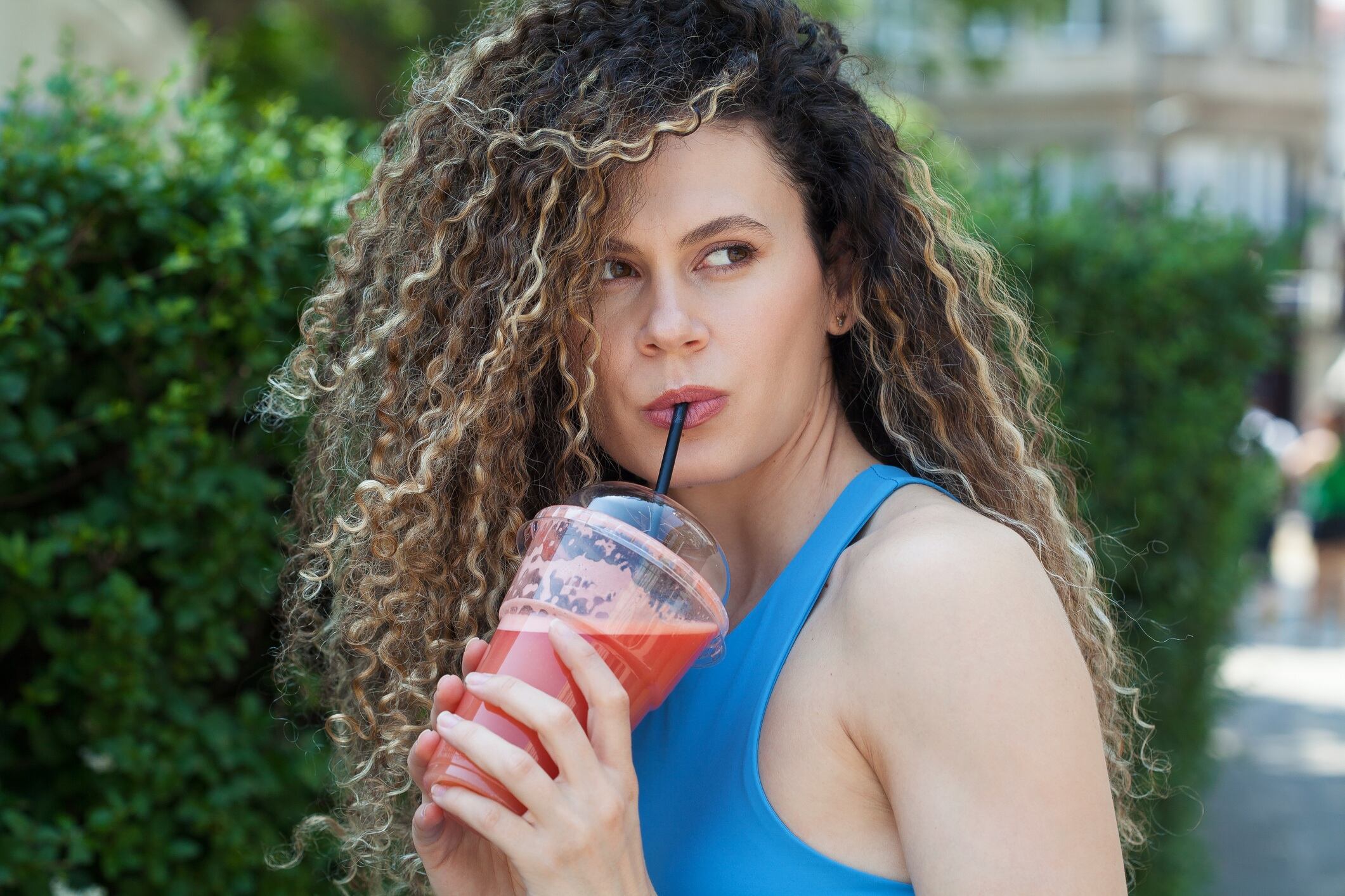 Young woman drinking grapefruit juice.